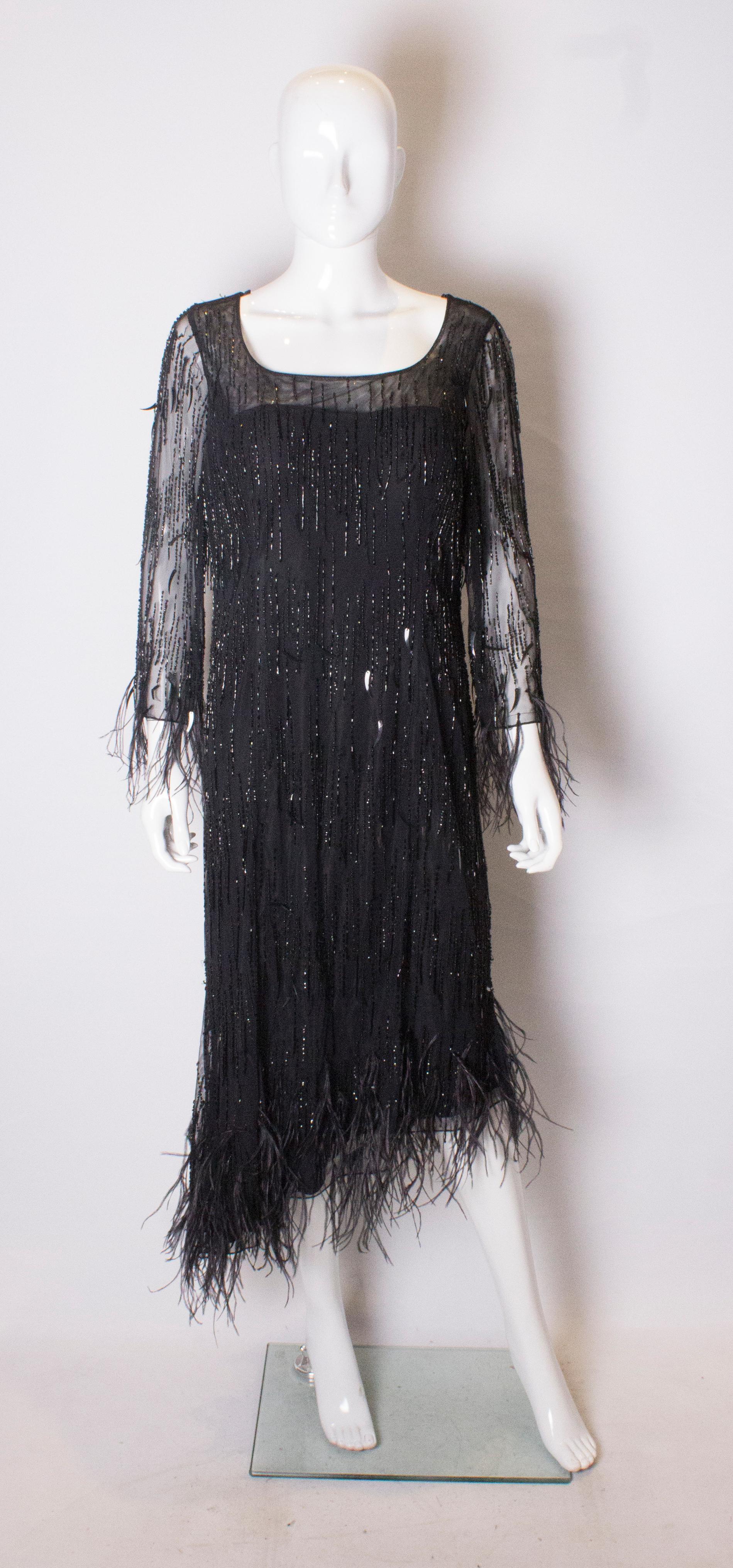 A head turning dress from Frank  Usher with bead and feather detail with an asymetric hem.