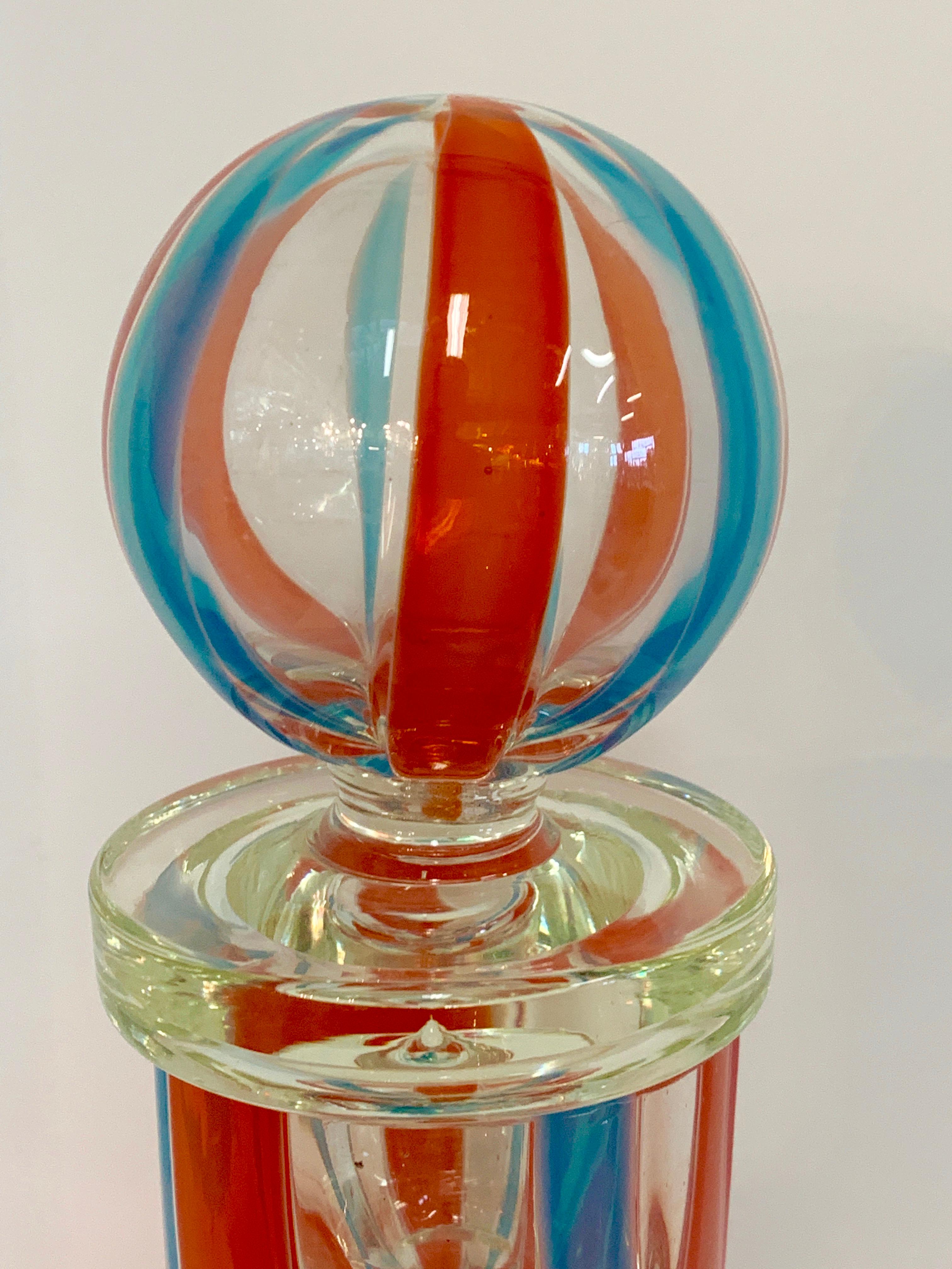A vintage labelled Fratelli Tosi (Toso) large striped bottle with stopper. It retains an old Murano Label which identifies it and dates it. Likely dates to the 1960s. The top of the bottle's interior rim has wear to it but this could have been