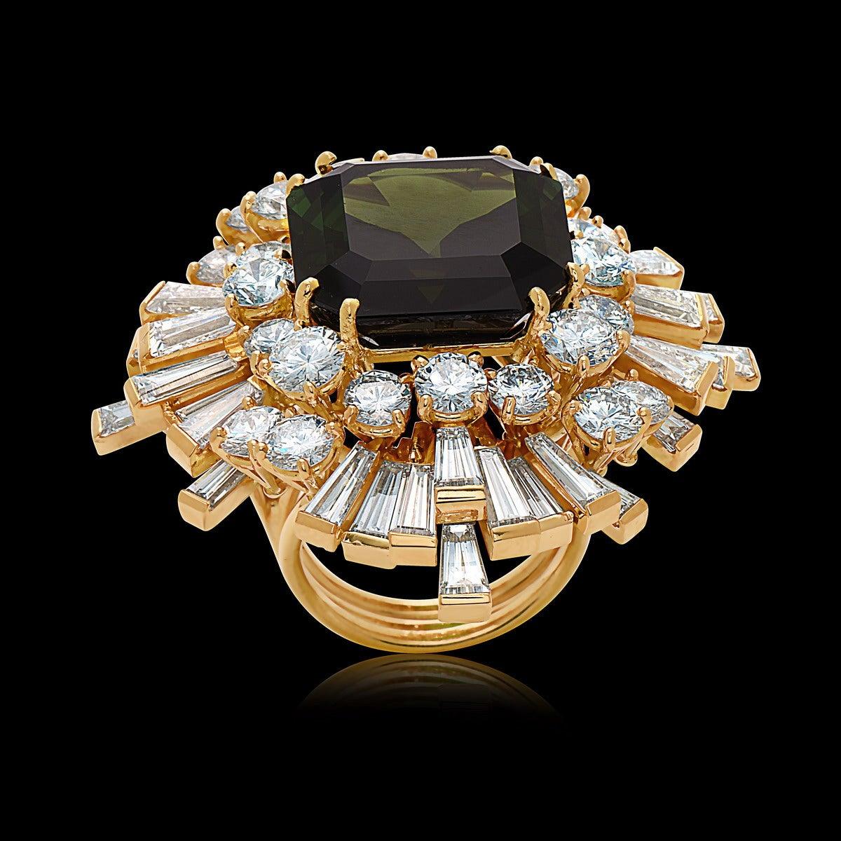 A signed Fred Paris cocktail ring featuring a 21.71 Carat Emerald-Cut, Dark-Green Tourmaline surrounded by a sprawling 15 Carats of White-Diamonds in a symmetrical design. The tourmaline is exceptionally clean and a fabulous dark green. In excellent