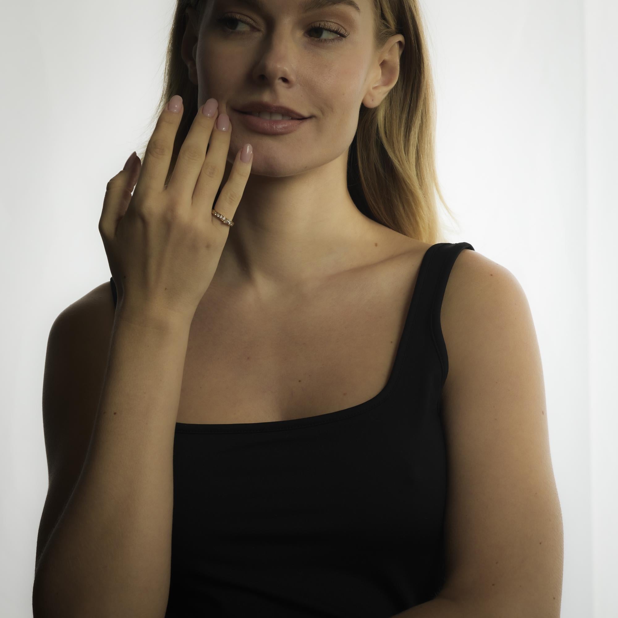 A refined Fred Paris creation, this 18k yellow gold ring features a marquise cut diamond of exceptional brilliance accented by sparkling round diamonds, exuding French elegance.