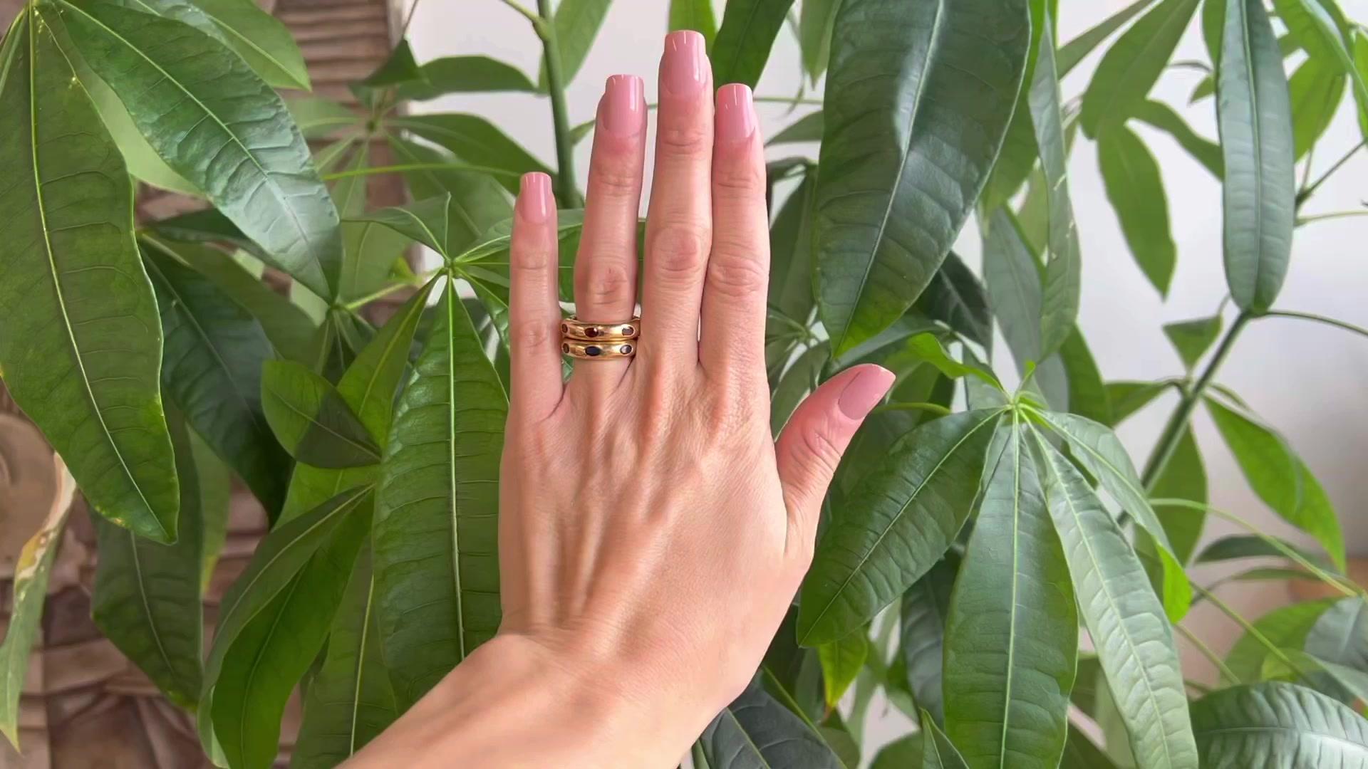One Vintage Fred Paris Sapphire Ruby 18 Karat Yellow Gold Band Ring Set. Featuring seven oval mixed cut blue sapphires with a total weight of approximately 1.85 carats, and seven oval mixed cut rubies with a total weight of approximately 1.85