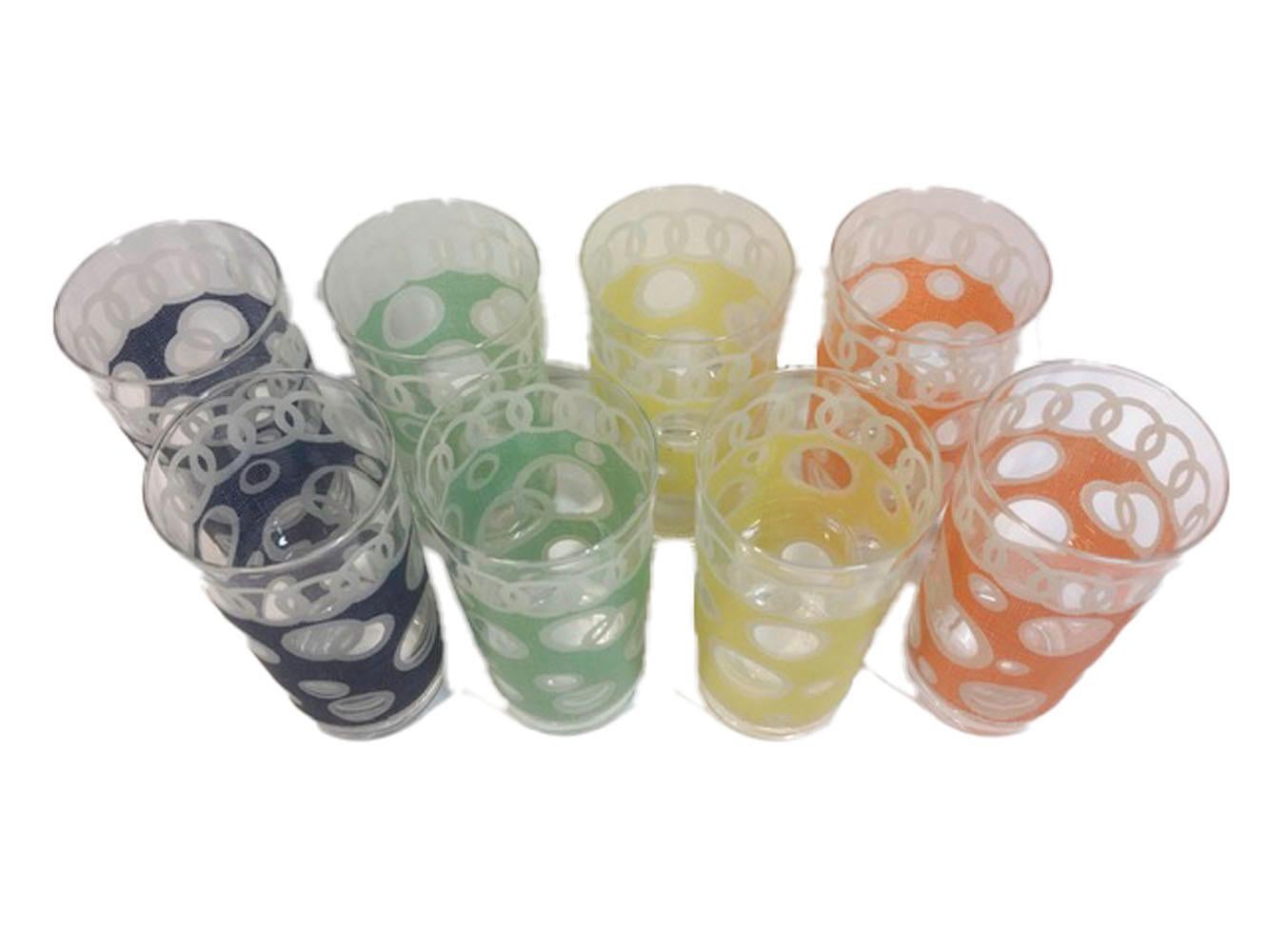 Set of 8 mid-twentieth century highball glasses signed Fred Press. Two each of four colors with white circles overlapped at the top and on the colored field, the colored field with a woven pattern in blue, yellow, green and orange. All in excellent