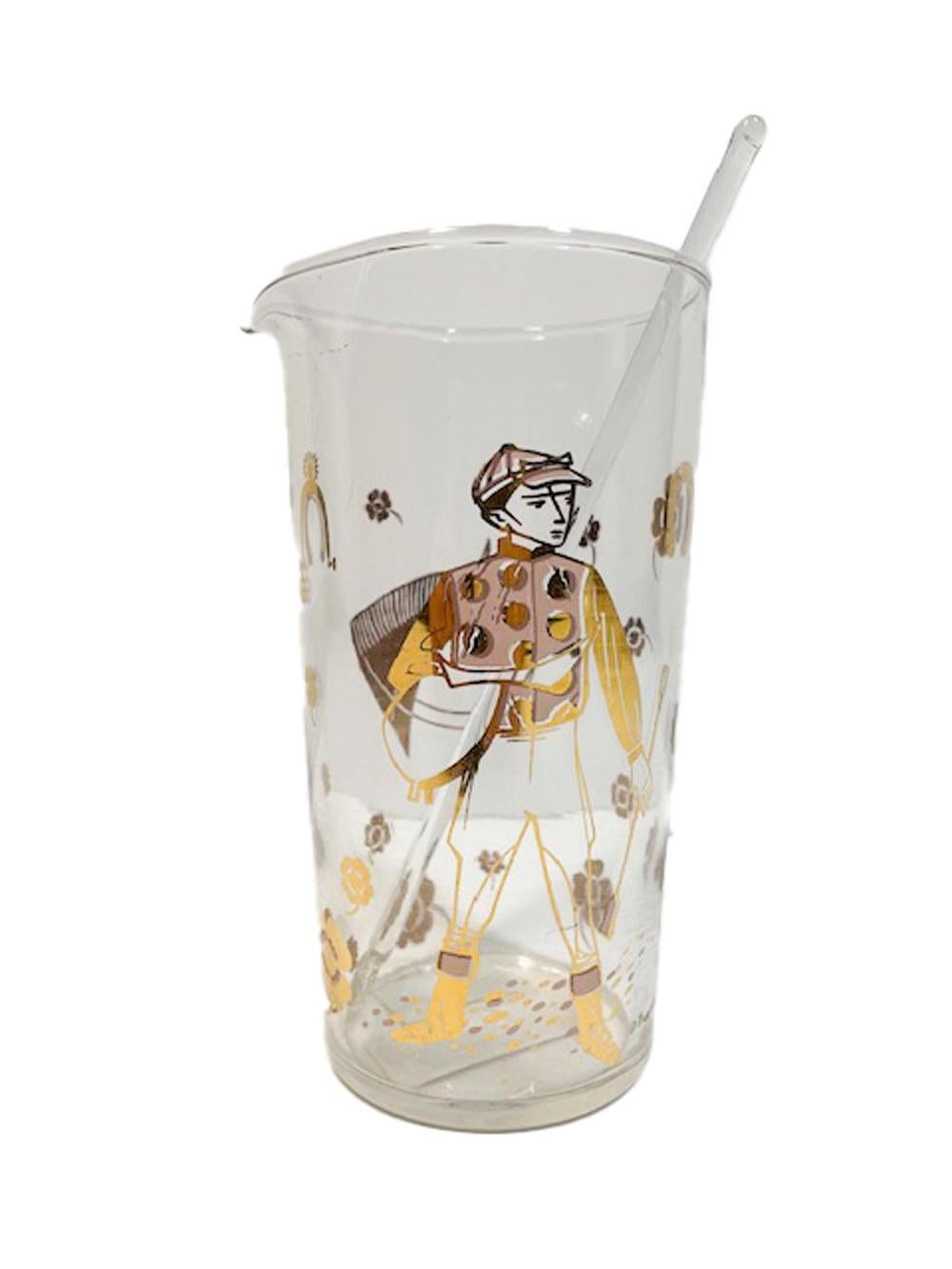 Mid-Century Modern cocktail pitcher and stirrer in clear glass decorated in the Derby Time pattern by Fred Press. One side is decorated in gold with the head of a thoroughbred race horse and the other with the image of a jockey in gold with pink