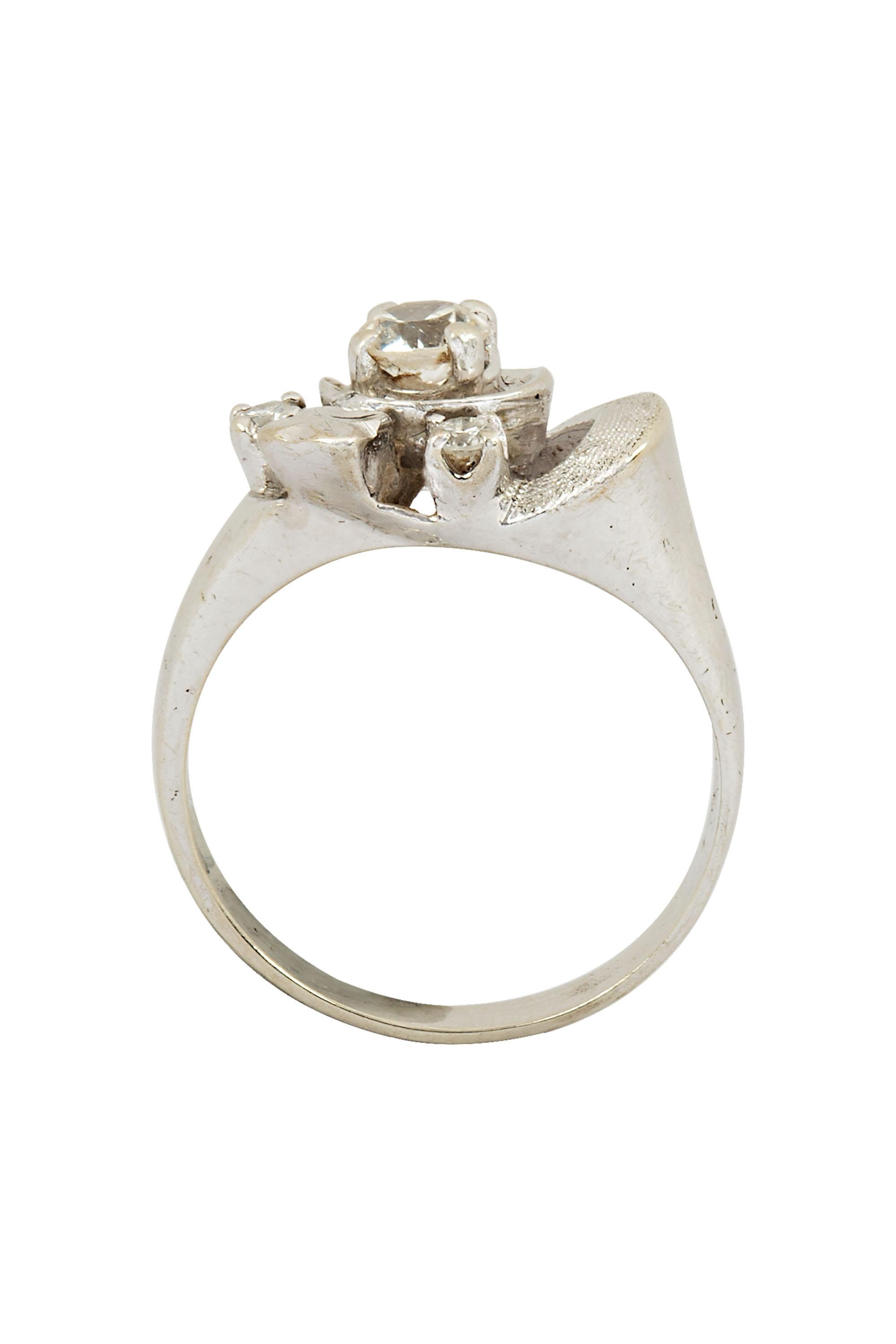 Whether you're dressing up or dressing down, this diamond ring is sure to add a touch of glamour to your look. Vintage 14K white gold diamond ring centered by an estimated 0.25 carat diamond and accented by two round stones, adding extra brilliance