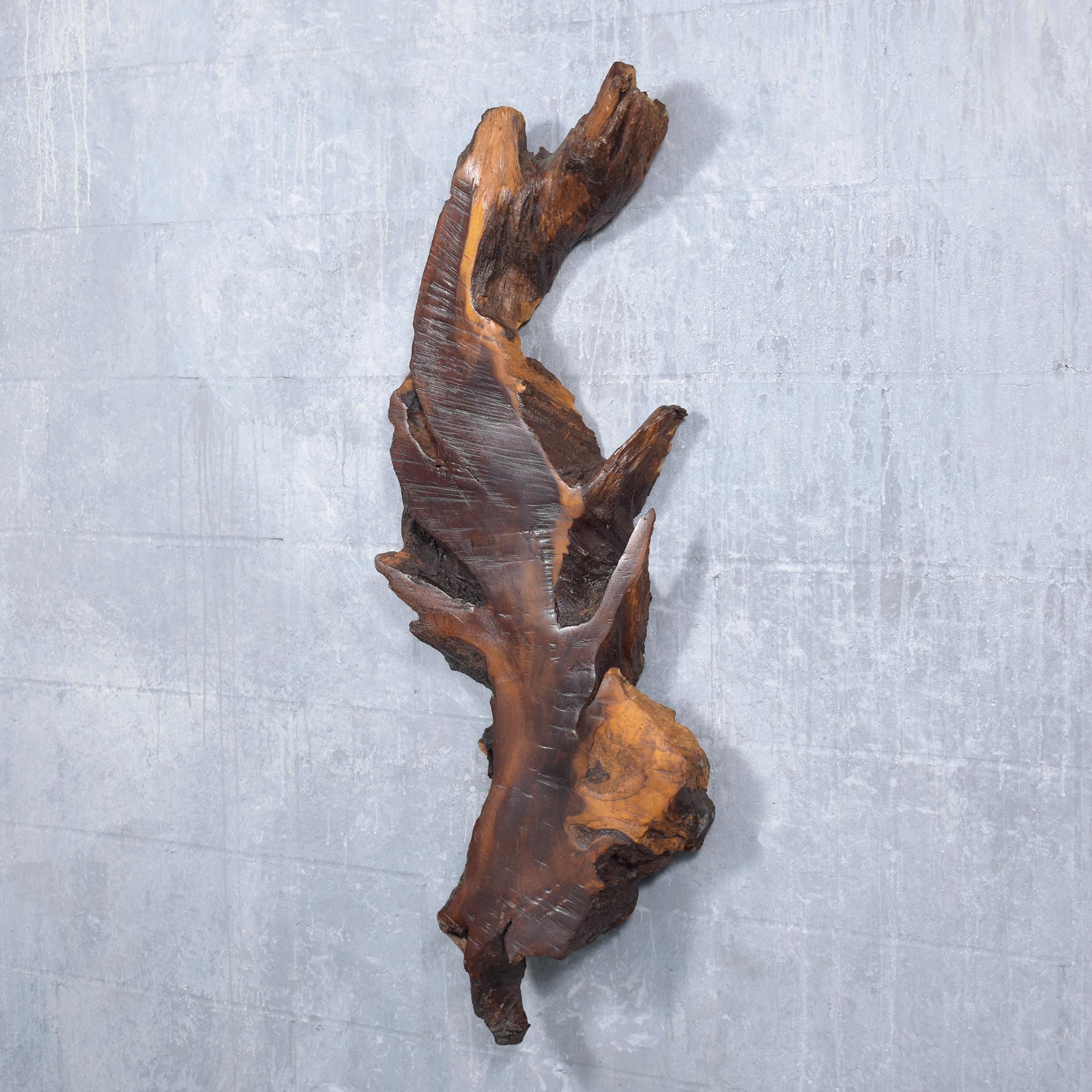 Elevate your interior with our vintage wall sculpture, a piece that beautifully captures the essence of natural elegance. Masterfully crafted from a solid wood slab, this sculpture is in excellent condition, showcasing the timeless appeal of quality