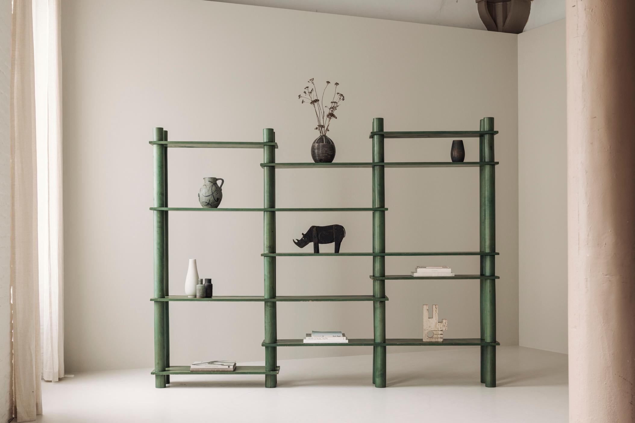Striking and versatile, this freestanding wall unit from the 1960s was sourced in France and embodies the spirit of mid-century design. Crafted from solid green stained ash wood, the unit is composed of modular components that allow for fully