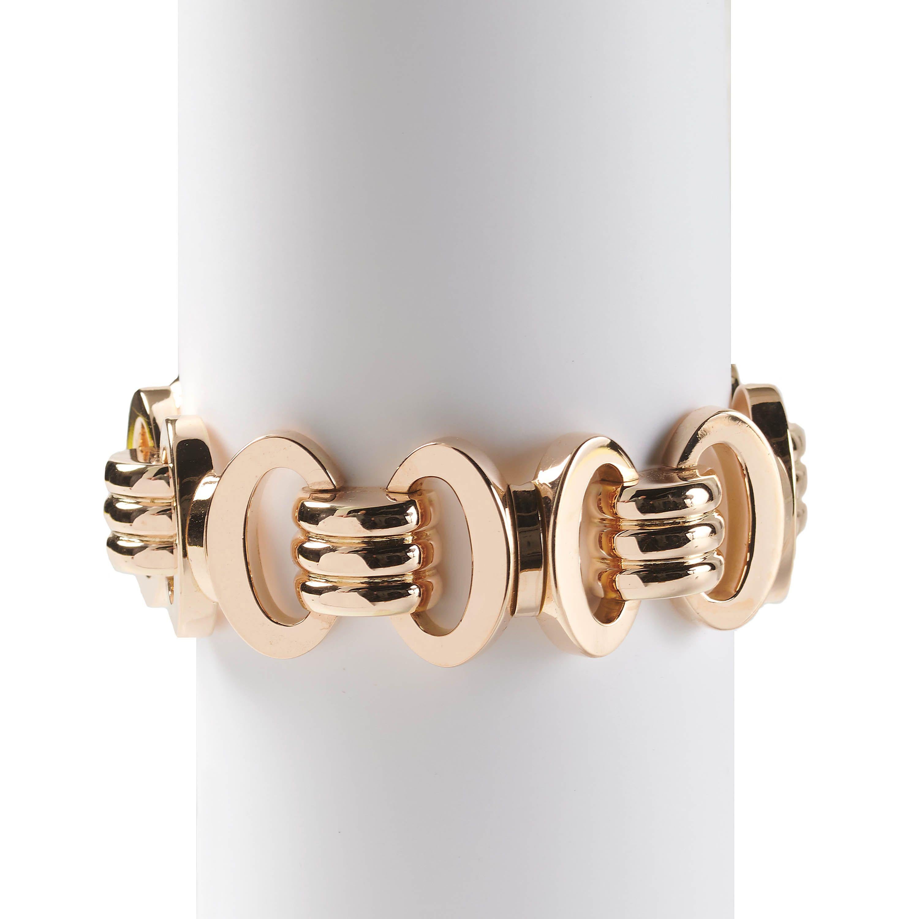 A French vintage rose gold tank bracelet, with alternating pairs of angled oval, hollow ware, links and triple row curved bars, mounted in 18ct gold, circa 1947.