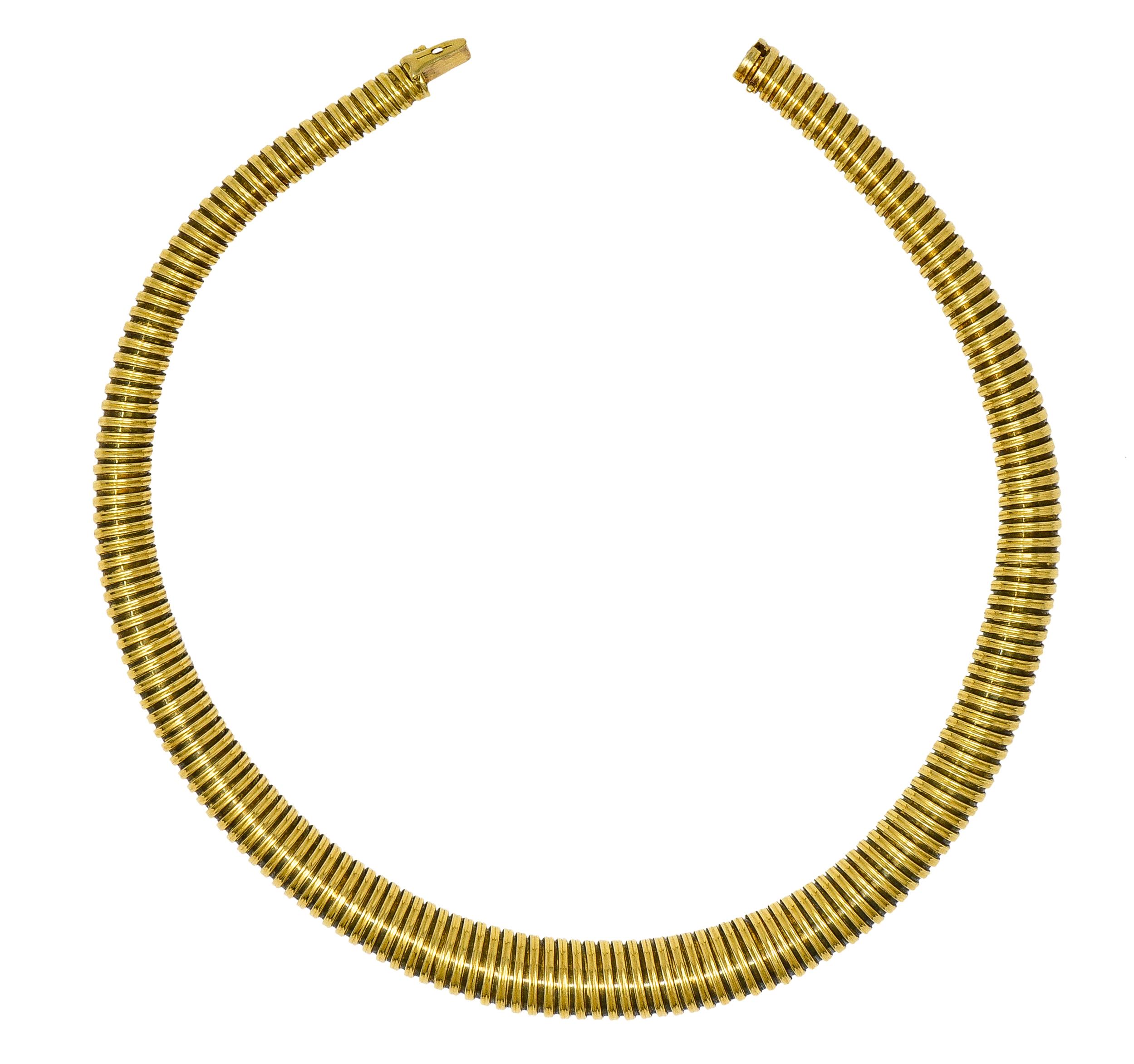 Designed as a round segmented tubogas chain. Segments graduate in size. With considerable flex. Completed by hidden clasp with hinged safety. Tested as 18 karat gold. With French Assay marks for gold import. Circa: 1970's. Width at widest: 1/2 inch.