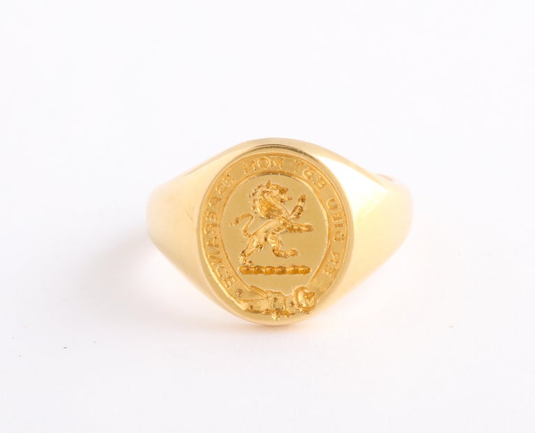 A striking medium sized signet ring, in 18 Kt gold, was made in France and engraved with a rampant lion in a garter motif. The message around the ring border is 