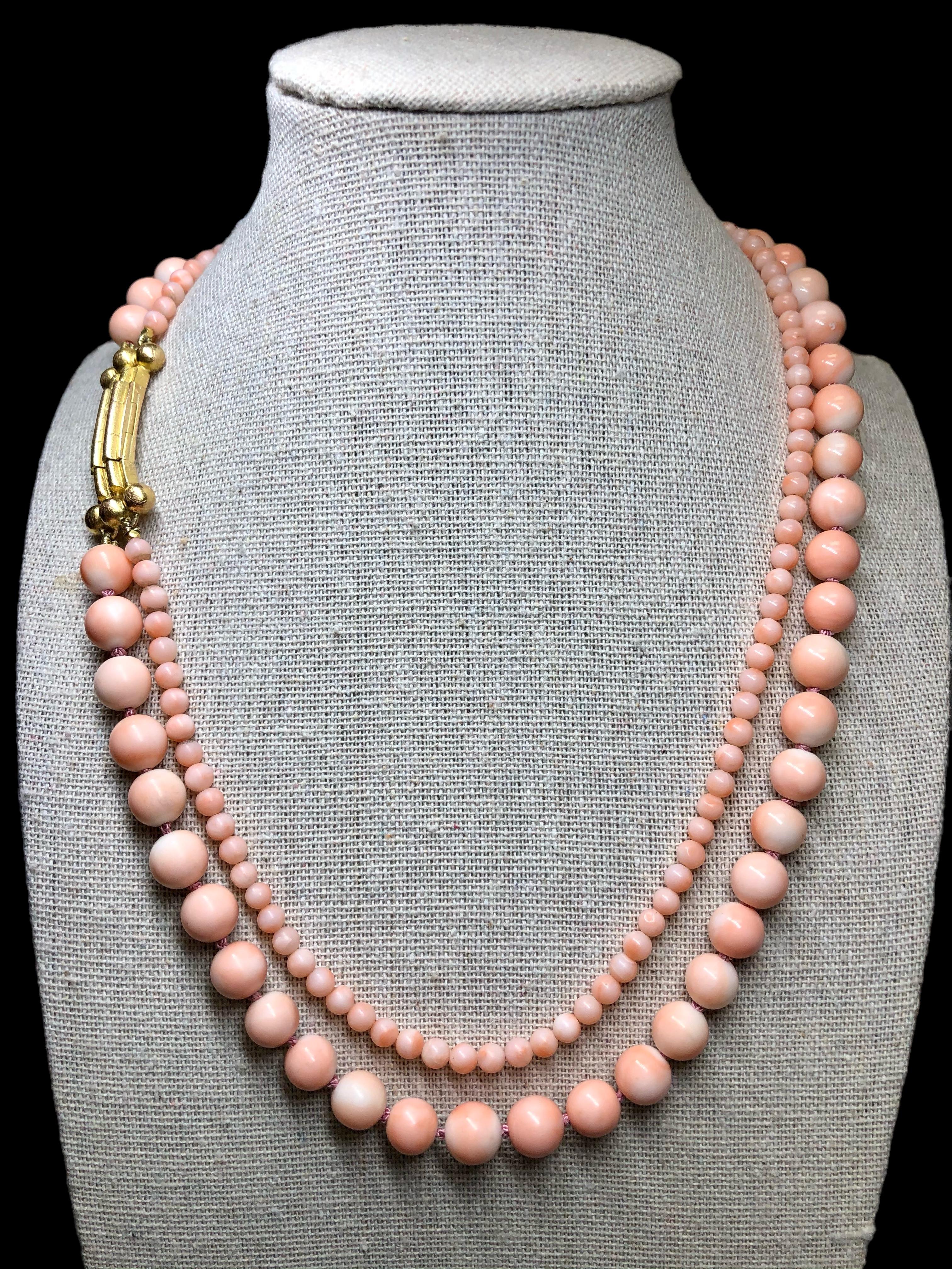 An elegant and unique French-made double strand coral necklace with 18K textured clasp with an open latch box clasp allowing a bit more length by changing position. Wears beautifully and is a welcomed addition to one’s own unique collection of fine
