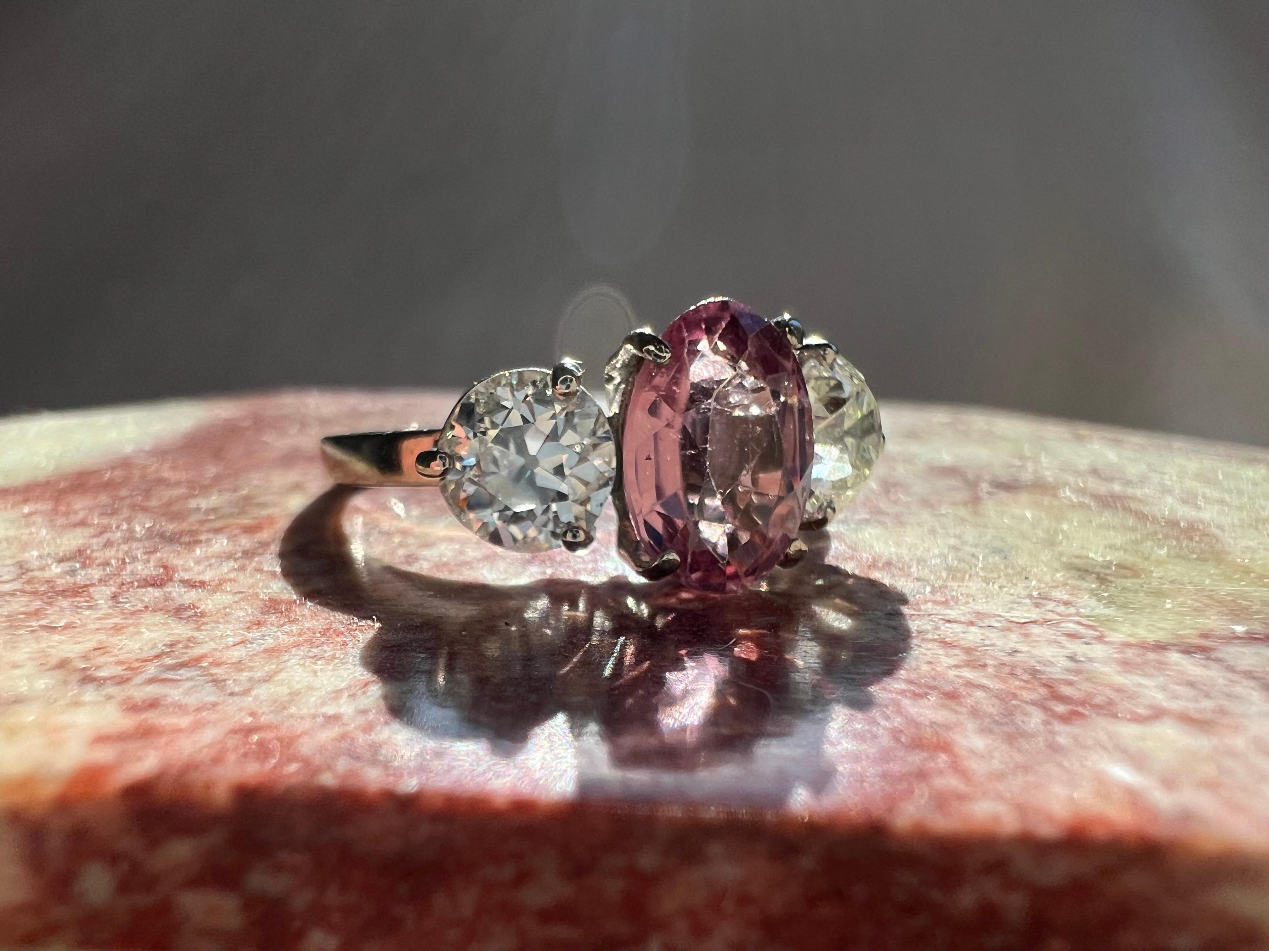 I have a gorgeous 3-stone vintage ring from France. 

The center stone is a pink tourmaline of about 1.15cts. On either side is an old European cut diamond, each about 1/2 a carat! One diamond is about G-H color and the other is I-J; however, this
