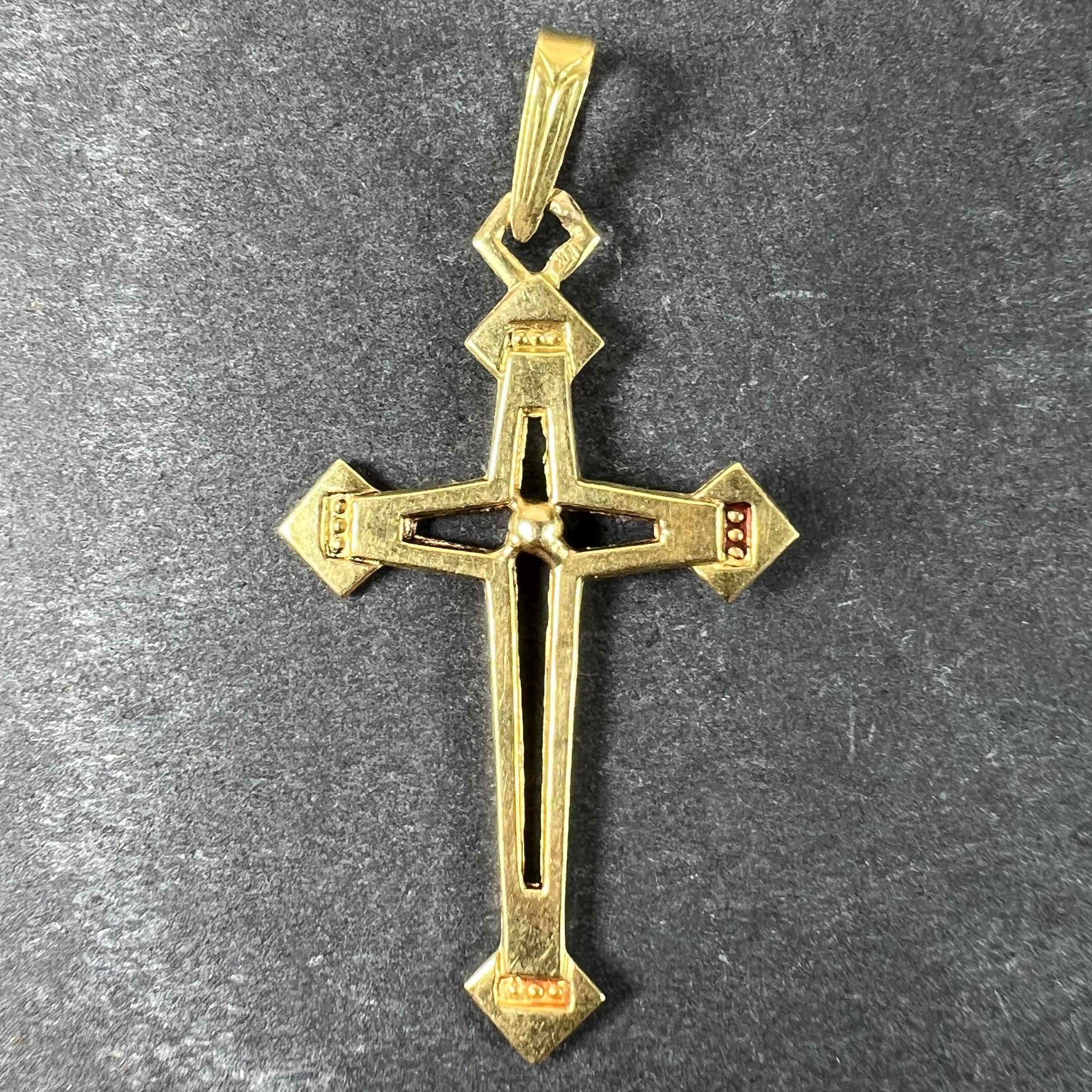 A vintage French 18 karat (18K) yellow gold pendant designed as a cross with pierced sections and ornamental terminations. Stamped with the eagle mark for 18 karat gold and French manufacture. 

Dimensions: 3.5 x 2.1 x 0.23 cm (not including jump