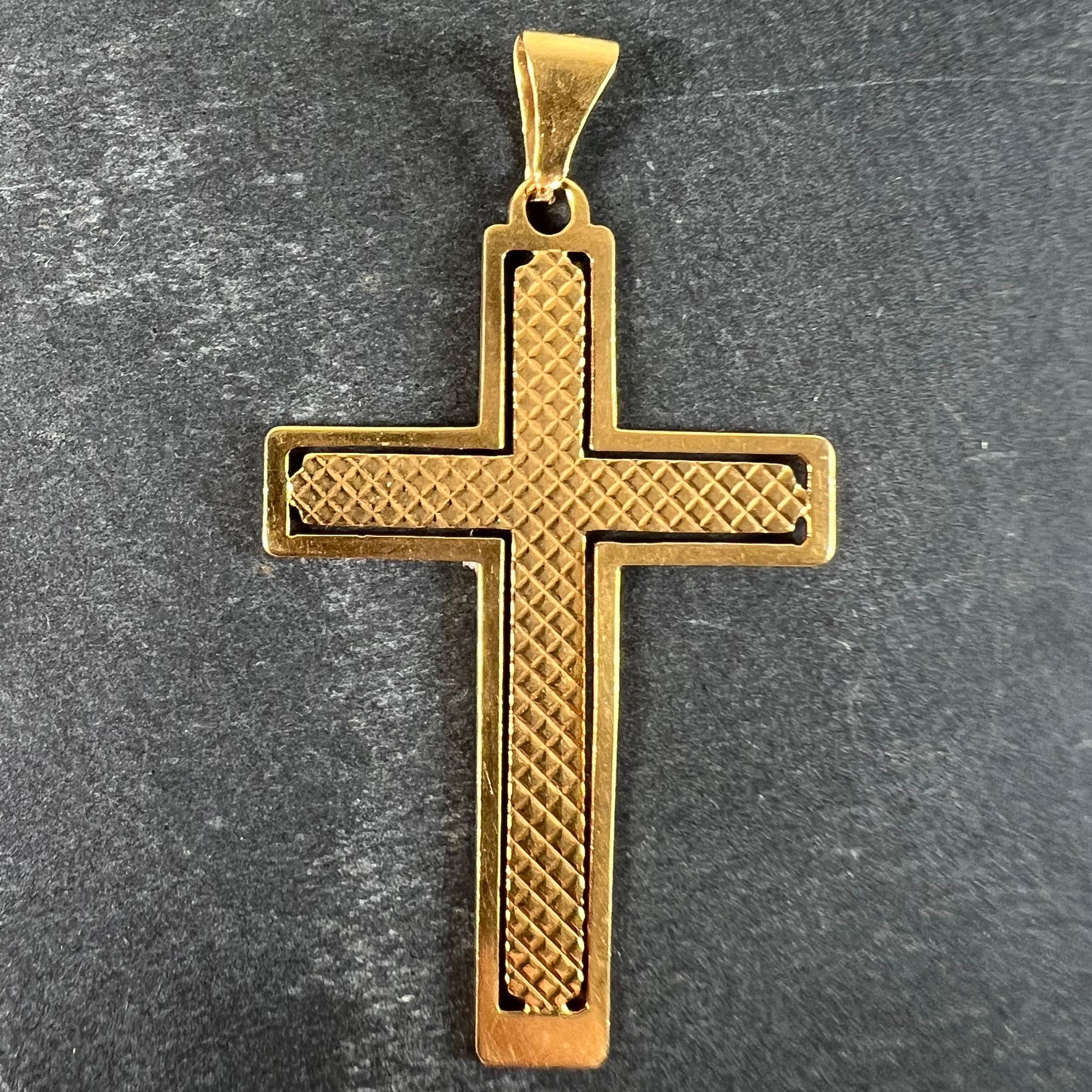 A vintage French 18 karat (18K) yellow gold pendant designed as a cross with pierced outline and diamond textured central section. Stamped with a maker's mark for French manufacture and tested as 18 karat gold.

Dimensions: 3.8 x 2.4 x 0.06 cm (not