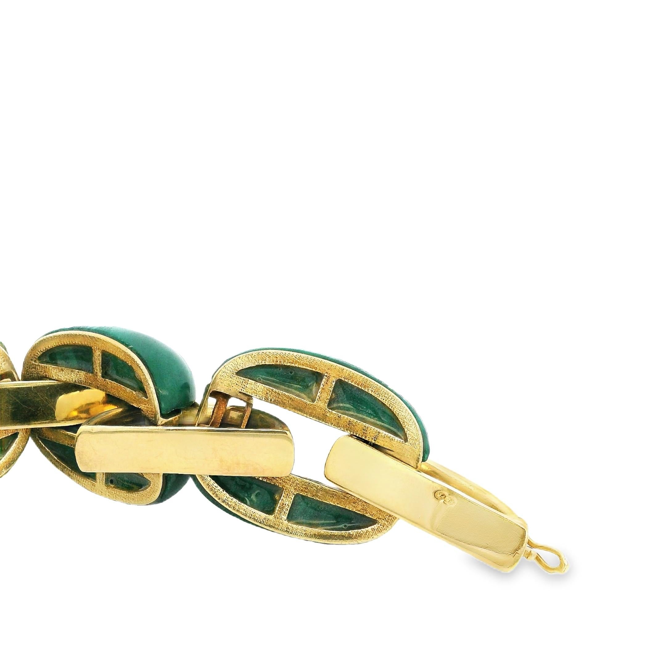 A striking statement of French craftsmanship, this vintage bracelet showcases a luxurious interplay of richly veined malachite cabochons and polished 18K yellow gold. Composed of bold, elliptical links, each malachite segment is carefully carved and