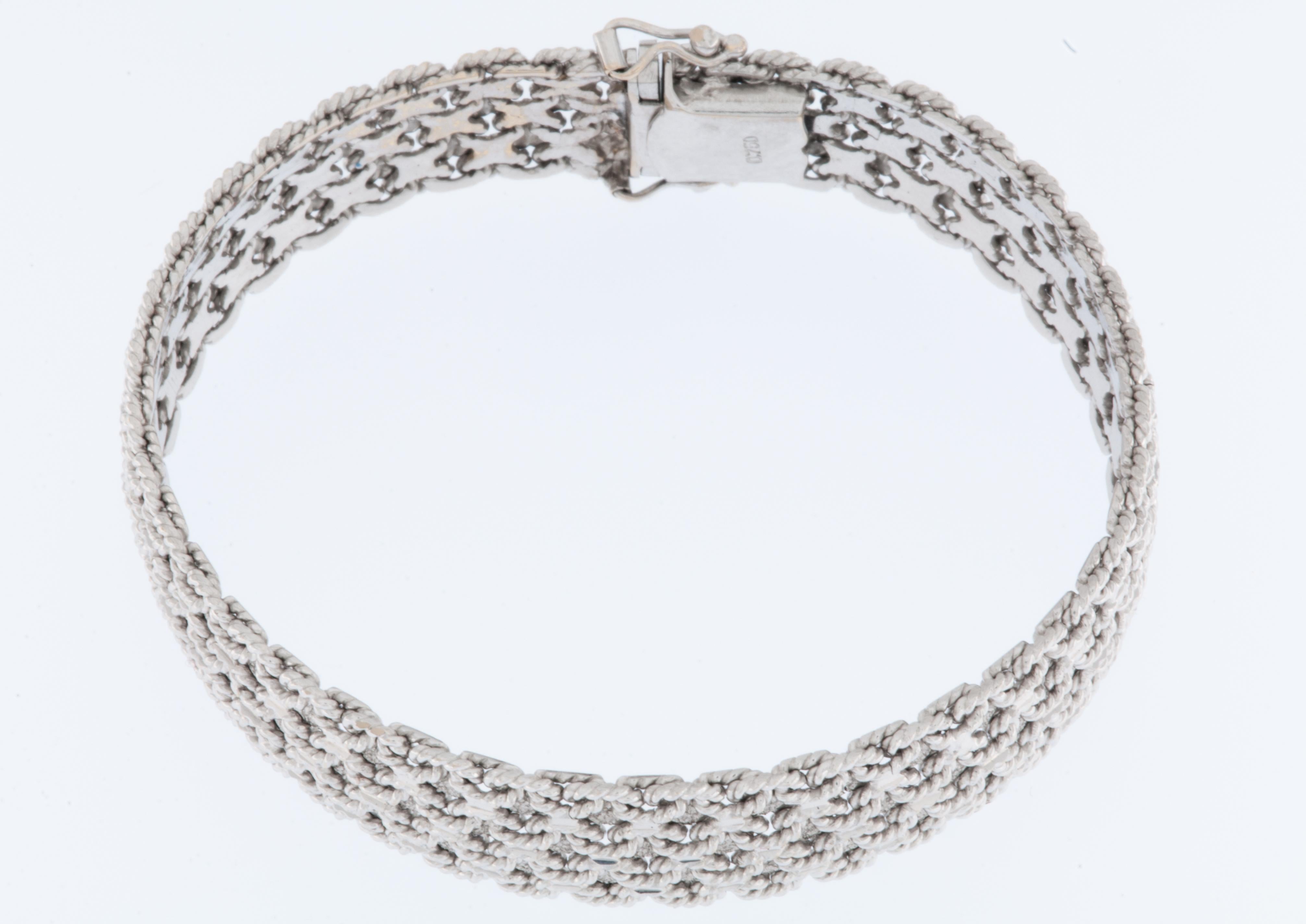 The Vintage French 18kt White Gold Bracelet is a stunning and intricate piece of jewelry. 

The bracelet is crafted from 18kt white gold, which is known for its durability and elegant appearance. White gold is a popular choice for fine jewelry due