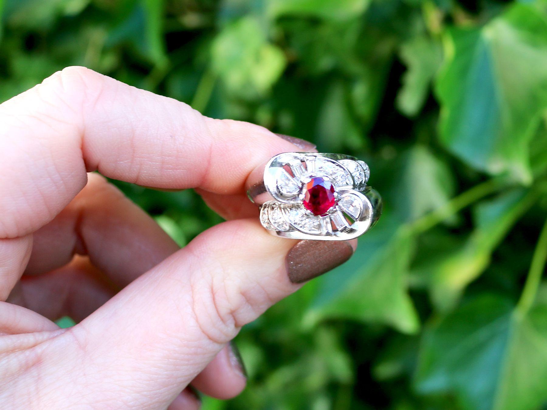 A fine and impressive vintage French 0.90 carat ruby and 0.48 carat diamond, platinum cocktail ring in the Art Deco style; part of our diverse vintage jewelry and collections.

This fine and impressive vintage oval cut ruby and diamond ring has been