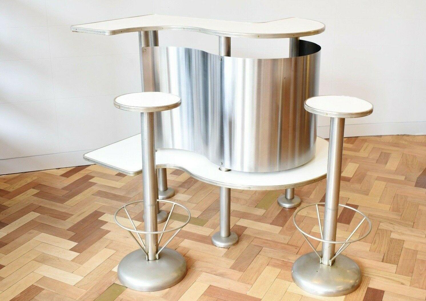A very rare 1950/60's French free standing bar with two stools. 

A great piece reminiscent of Mid-Century Modern Space Age design made from aluminium and white formica with a bottle holder to the inside. 

This bar would make a great feature in