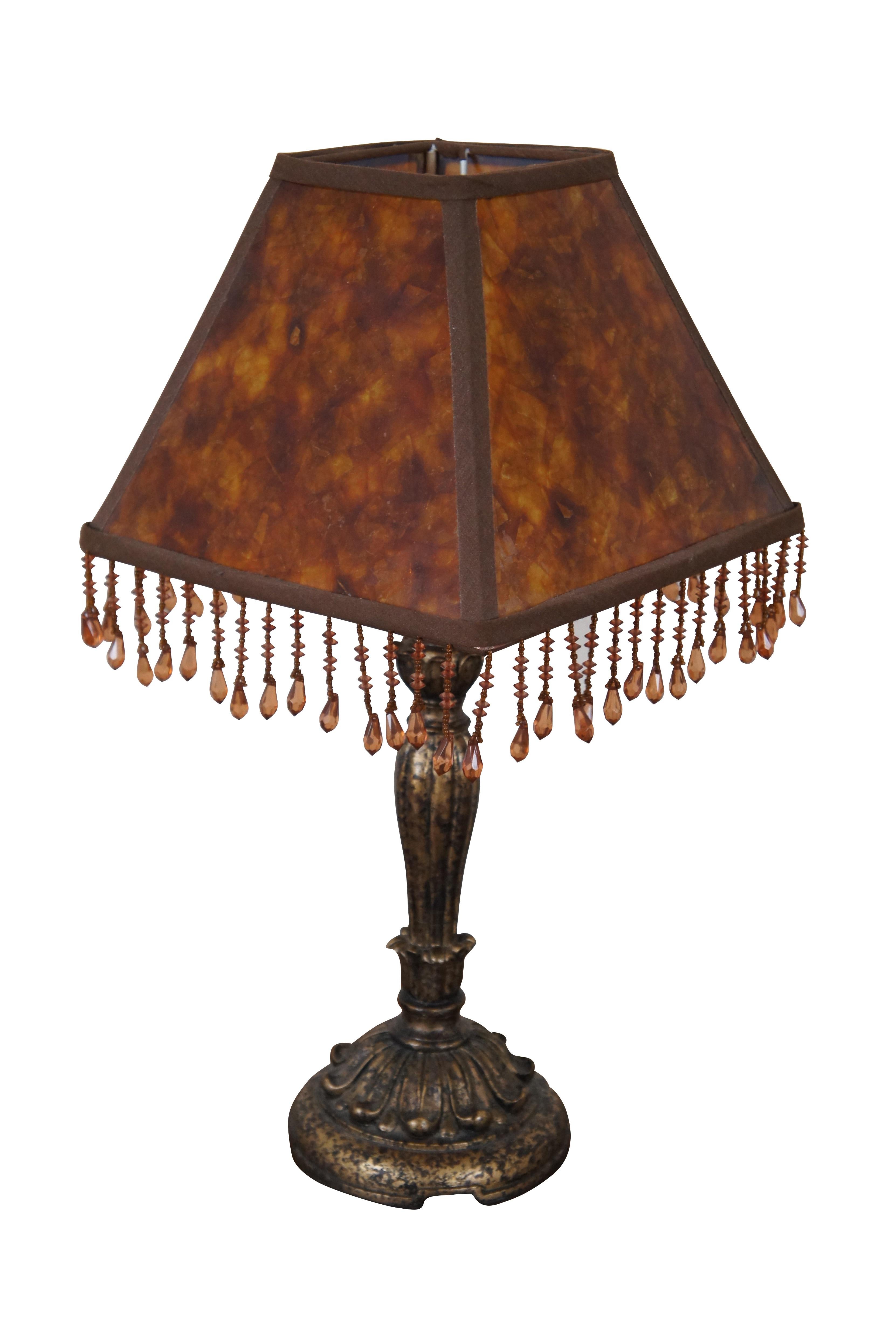 Vintage desk or table lamp featuring French style composite body with acanthus design and penshell style shade with beaded style drop crystals.

Dimensions:
5.5” x 14.5” / Shade - 9.5” x 9.5” x 7” (Width x Depth x Height)