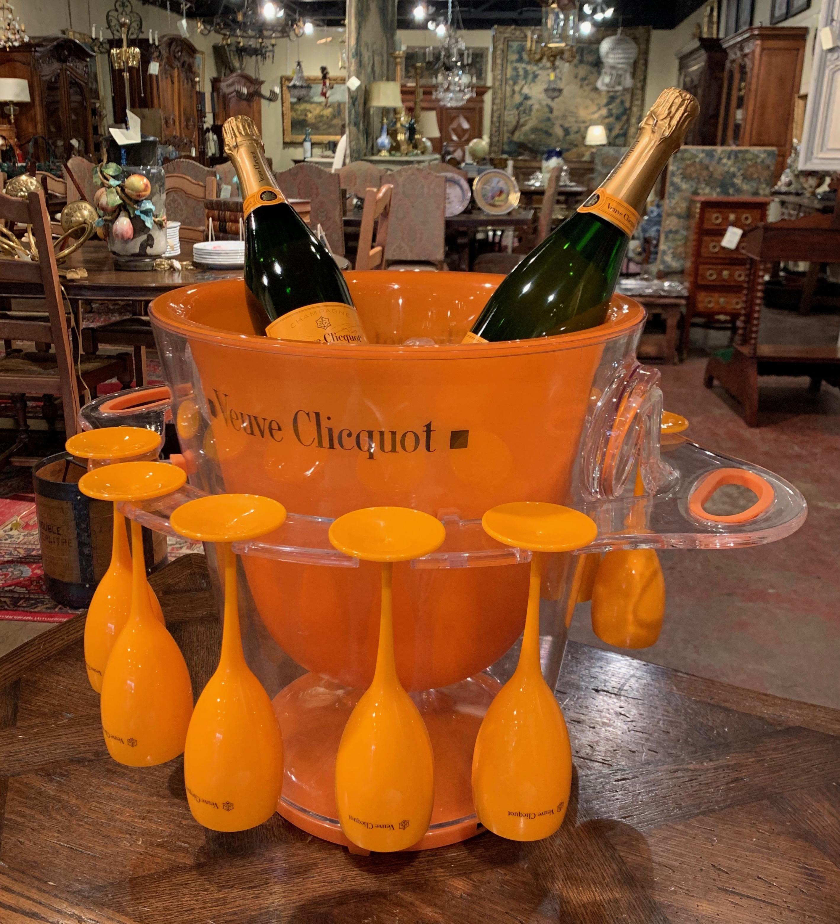 Decorate a pool wet bar with this elegant champagne cooler with matching glasses; crafted in France, circa 1980 by the iconic House of Veuve Clicquot, the two-piece container features an orange bowl decorated with clear handles and slots for ten