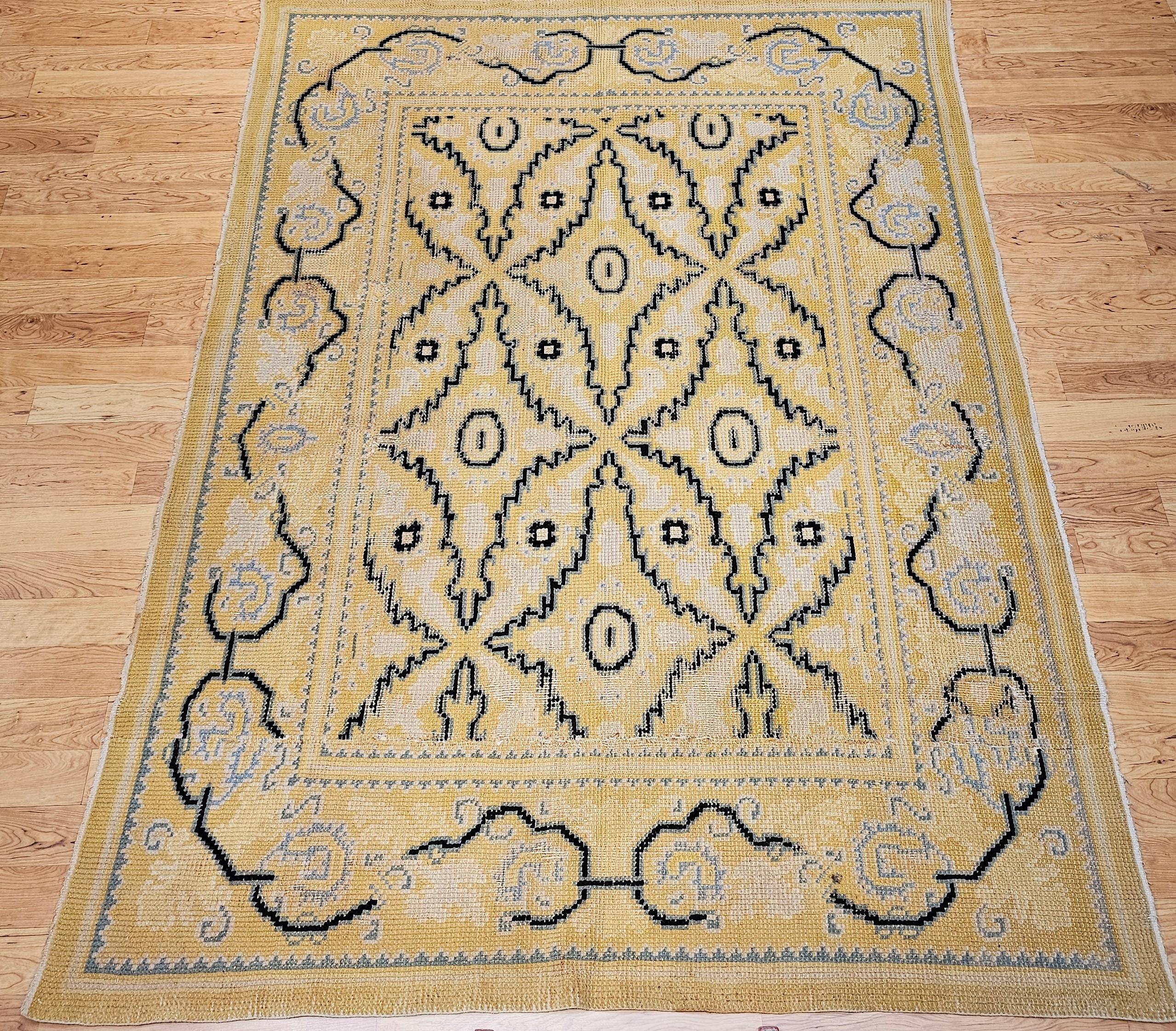Vintage room-size hand-knotted French rug  with a modern all over geometric pattern in yellow, pale blue, back from the first quarter of the 1900s.   The design and colors used in the rug are reminiscent of vintage mid century Swedish rugs and