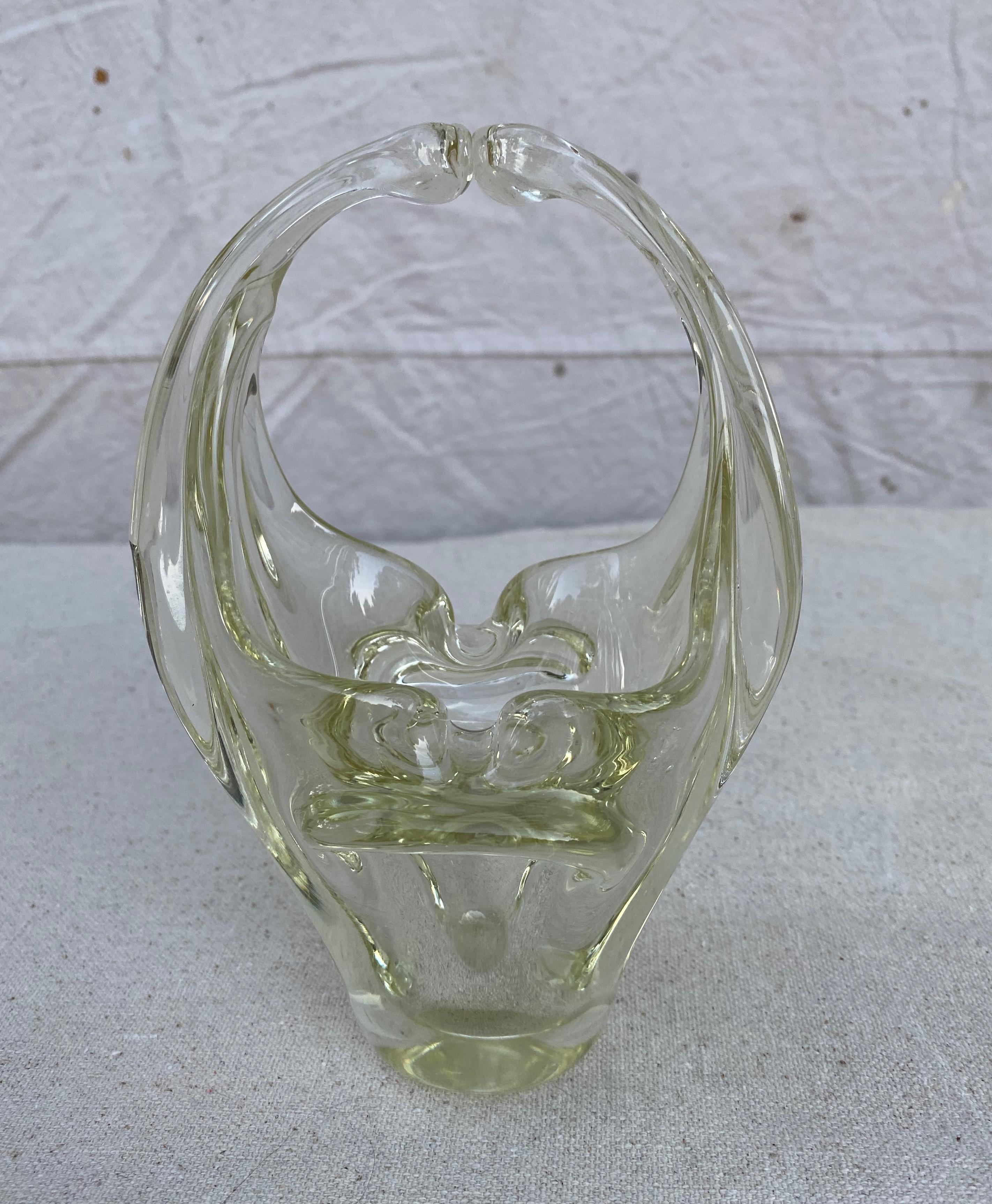 A stunning French hand blown Art De Vannes decorative bowl, lightly tinted green that gives a interesting depth to the piece. The base is formed in sculptural shapes that rise up into a double winged shape. French 1960s.

Stamped on the bottom