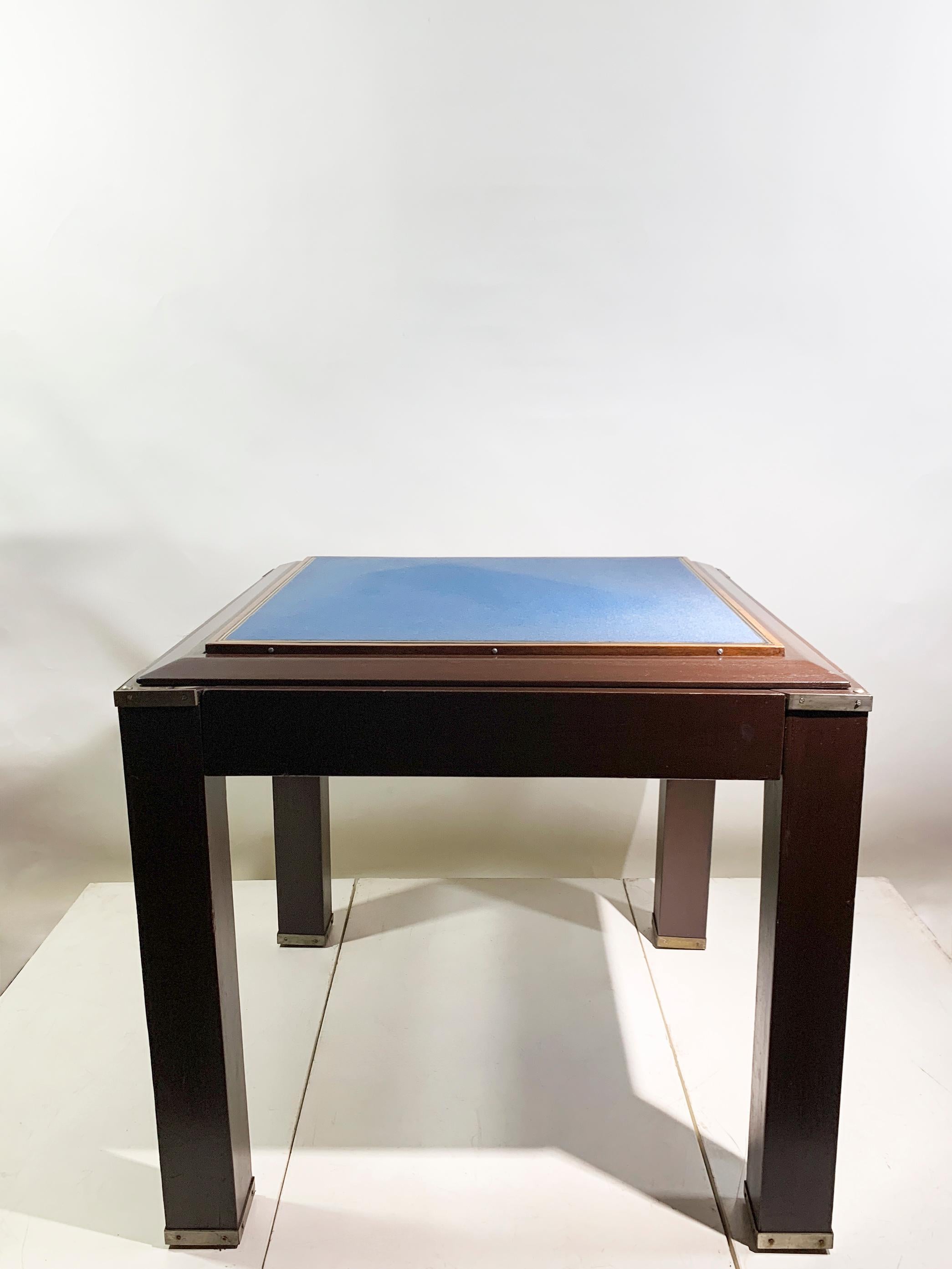 An elegant and highly functional Mid-Century Modern game table, crafted circa 1950. This piece is a sophisticated example of the era's focus on both clean design and clever functionality. It is not defined by an organic or sculptural form, but