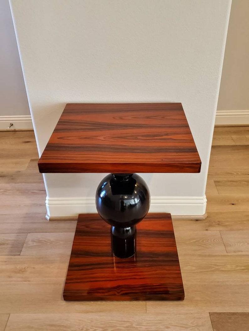 A stunning French Modernist geometric orb pedestal table, exquisitely hand-crafted, exceptionally executed in Art Deco - Streamline Moderne period styling, artistic sculptural form, having a thick solid wooden square top finished in exotic and