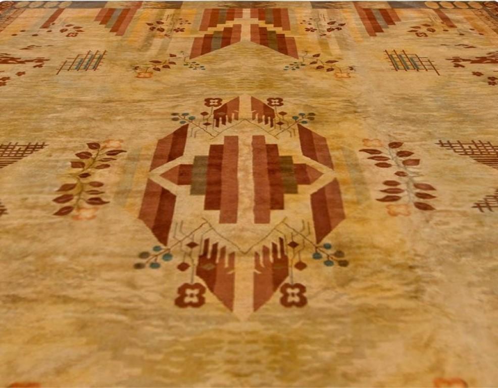 Vintage French Art Deco handwoven wool rug
Size: 11'8” x 13'2” (355 x 401 cm)
An exceptional early 20th century French Art Deco modern carpet, the sand field with scattered red, brown and beige geometric and floral motifs, including grids and
