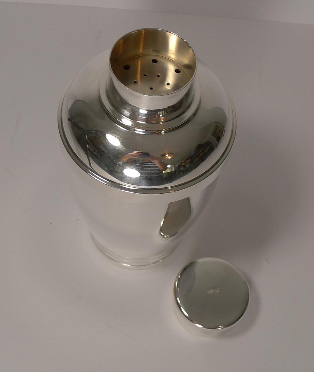 A fabulous quality French cocktail shaker, a hefty weight and solidly made. Just back from our silversmith, where it has been professionally refurbished to it's former glory.

An unusual chunky shape with a clear Art Deco design. The lid is where