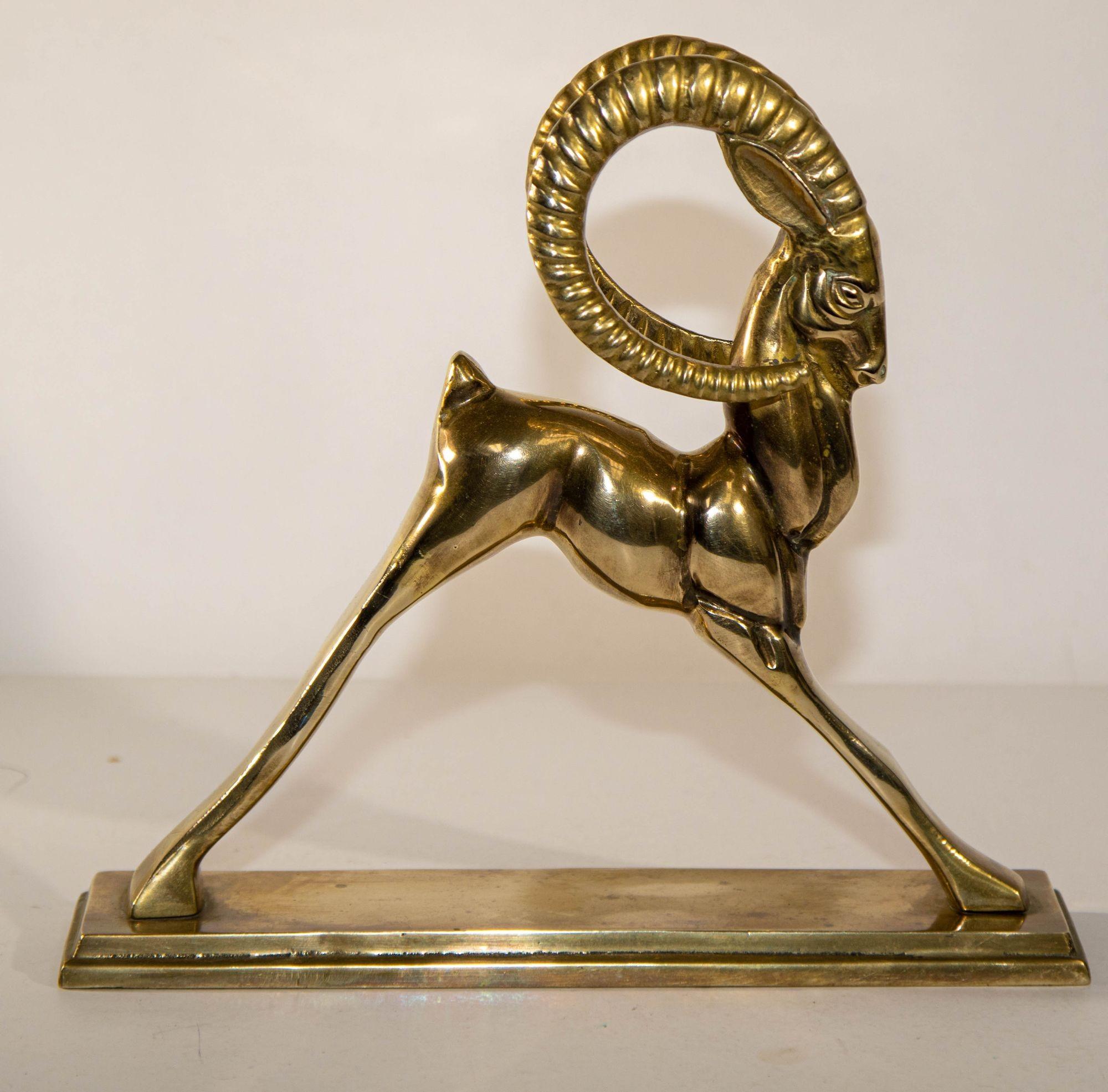 Vintage French Art Deco Style Sculpture of Brass Ibex Antelope.
Solid cast brass Ram decorative object or bookend, circa mid 20th century.
Beautiful elegant art Deco Hollywood Regency style cast brass ram, gazelle antelope sculpture mounted on a