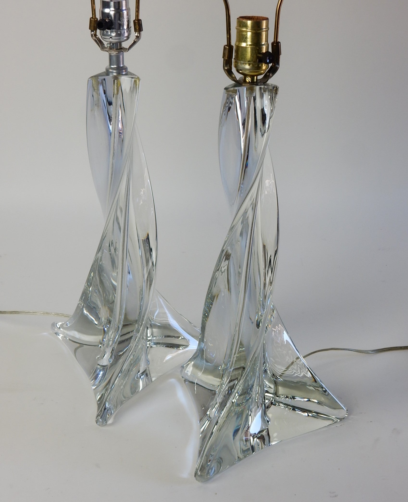 A pair of vintage art glass table lamps by St. Louis Crystal of France.
Bespoke crystal glass forms that produce a dazzling refractive gem-like sparkle. They are fabulous!
Both lamps are acid etched 