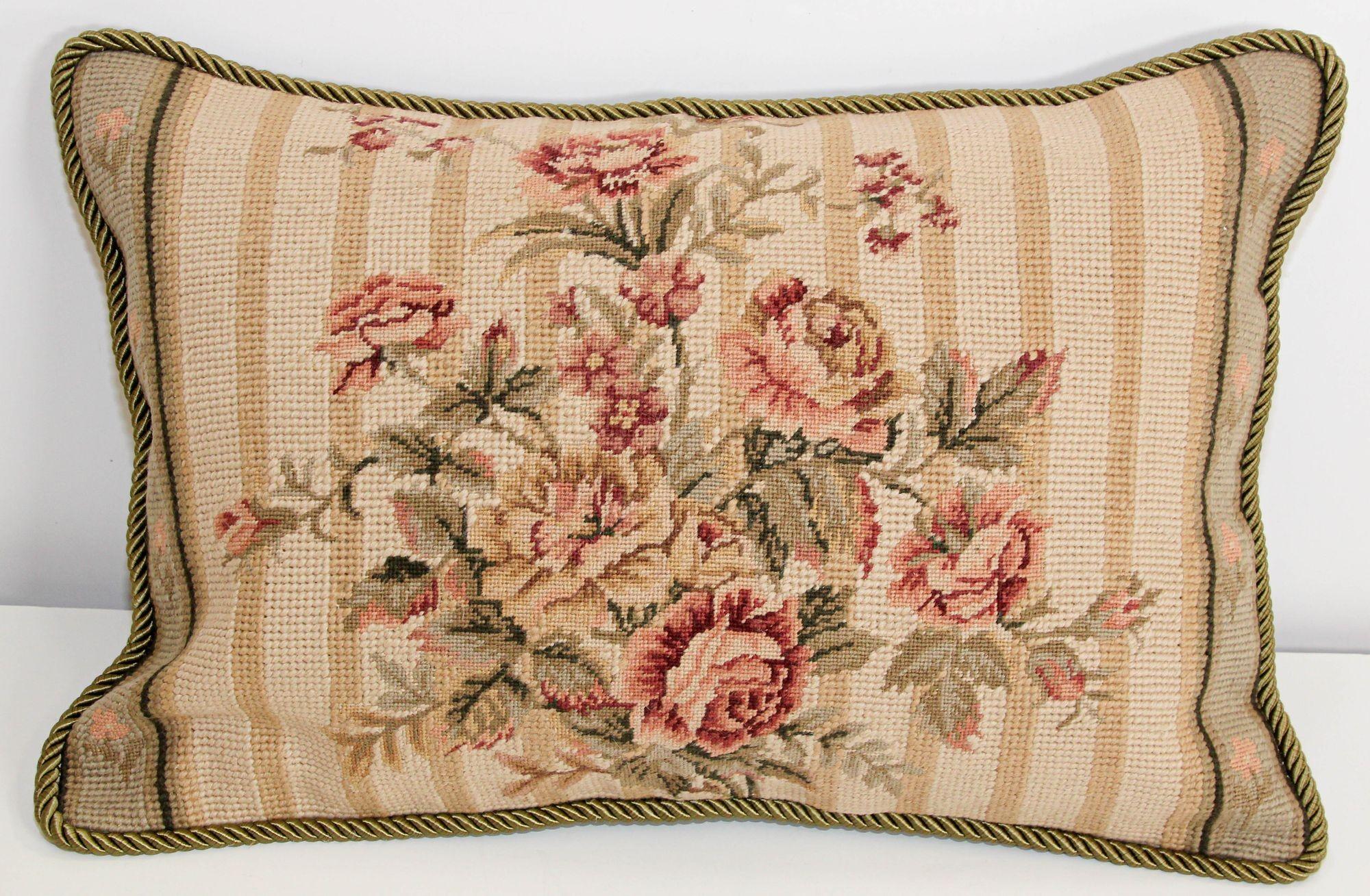 Vintage French Aubusson Tapestry style needlepoint lumbar pillow.
This Aubusson style pillow features a charming bouquet of pink roses, seen in a horizontal format. Their pink and white tones, contrasted with the green hue of the foliage, stand out