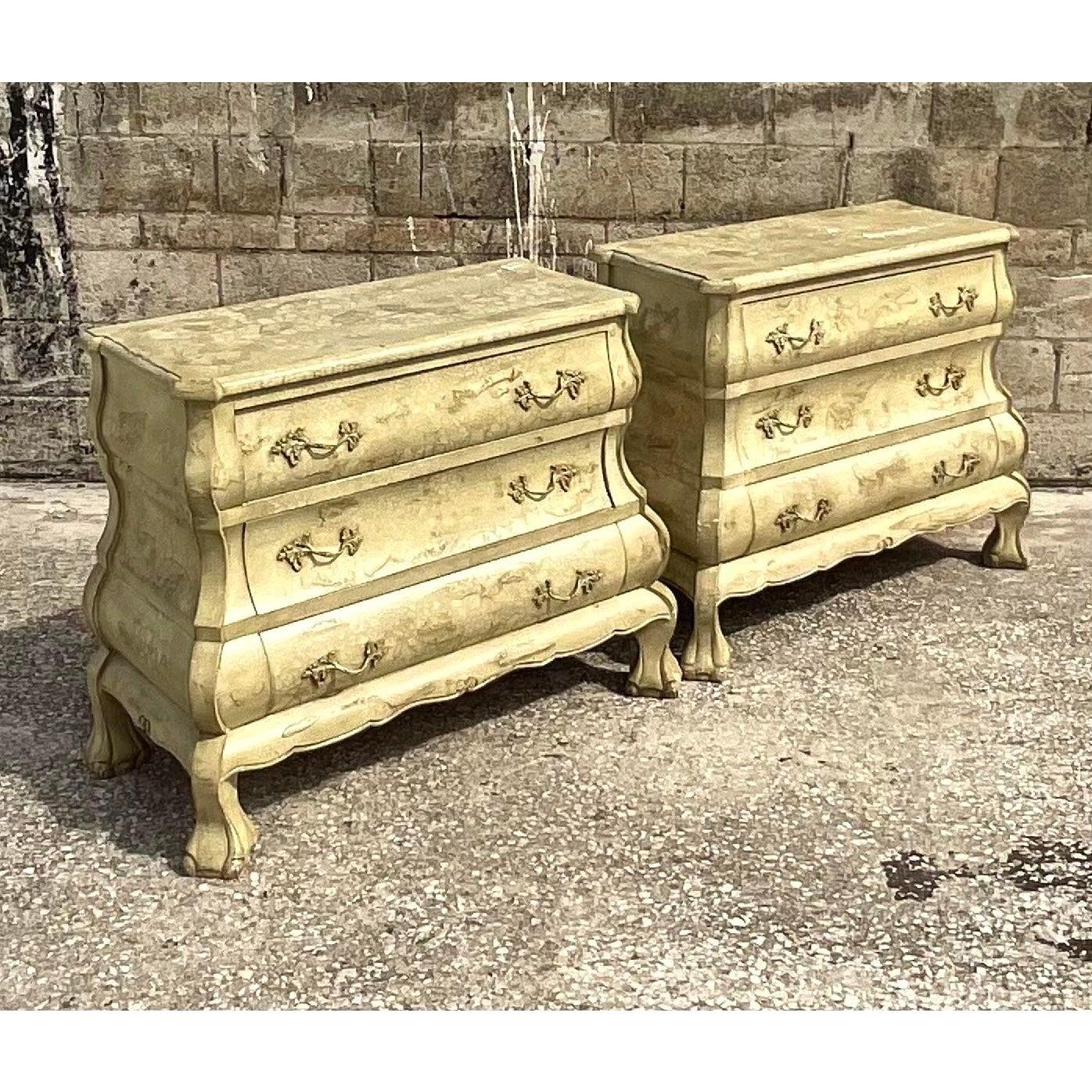 Fantastic pair of vintage French Bombe chests of drawers. Beautiful textured finish in a chic pale green color. Lots of big chunky hardware. Great as chests, but would also be super as nightstands. Acquired from a Palm Beach estate.