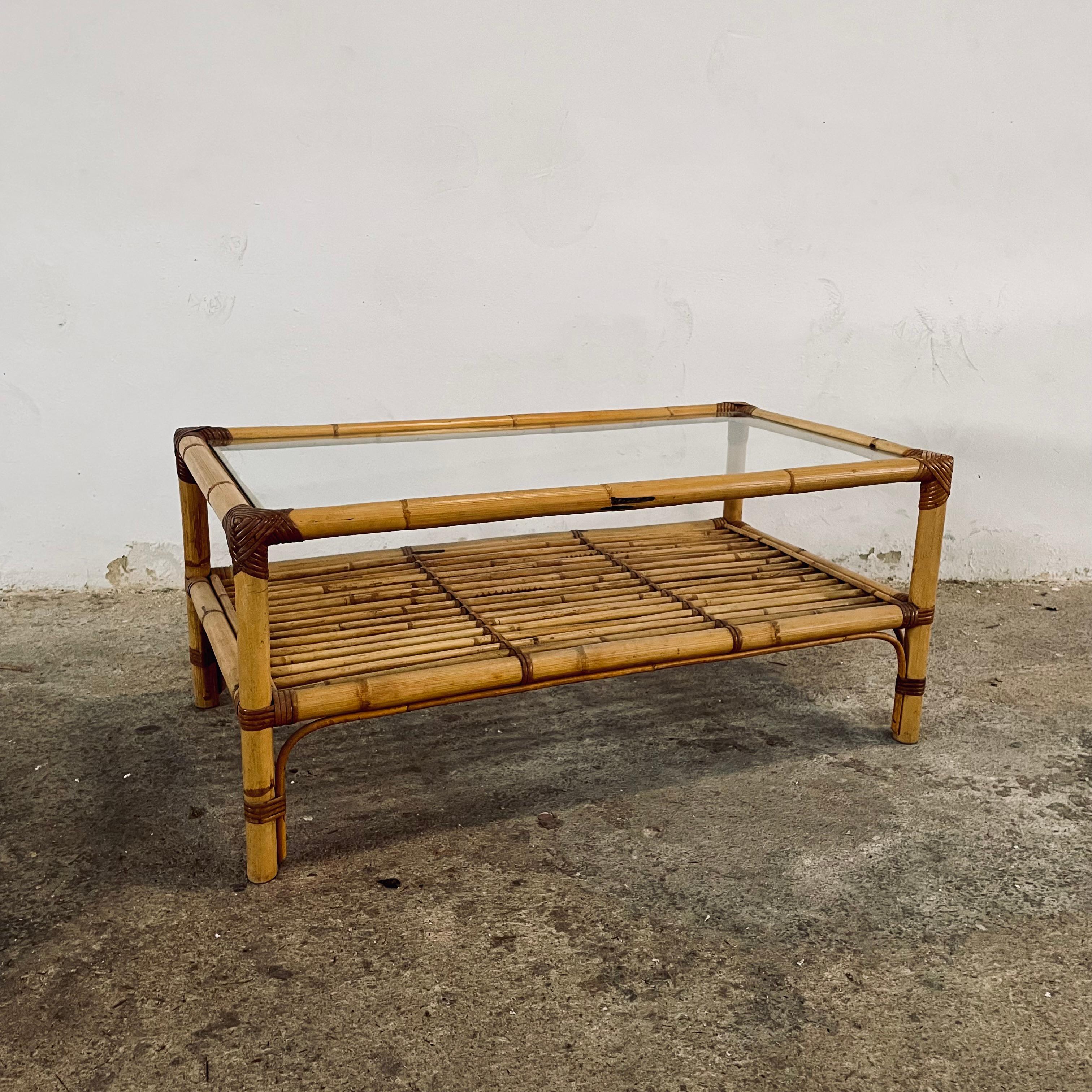 Gorgeous 1970s French bamboo and rattan coffee table or side table with glass top, two tiers or shelves with planty of display and storage space.
This vintage item remains fully functional, it may show signs of age through minor scuffs, dings,