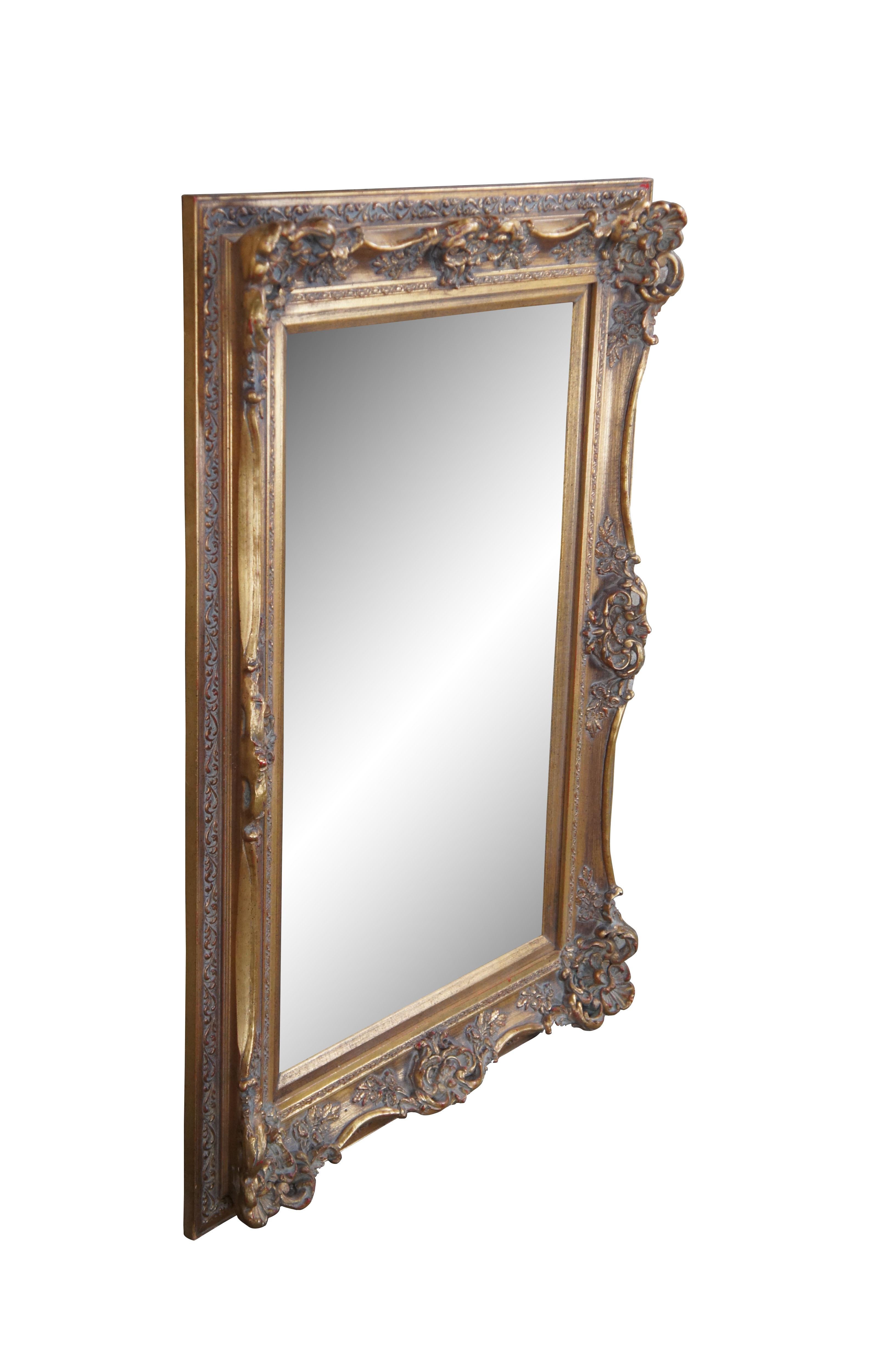 Vintage French Baroque Style Rectangular Gold Beveled Glass Mirror.  Featnures serpentine raised foliate relief and beveled plate glass.  Finished in Gold.  A nice addition to any wall, bathroom, entryway, hallway or over mantel.  

Dimensions:
42