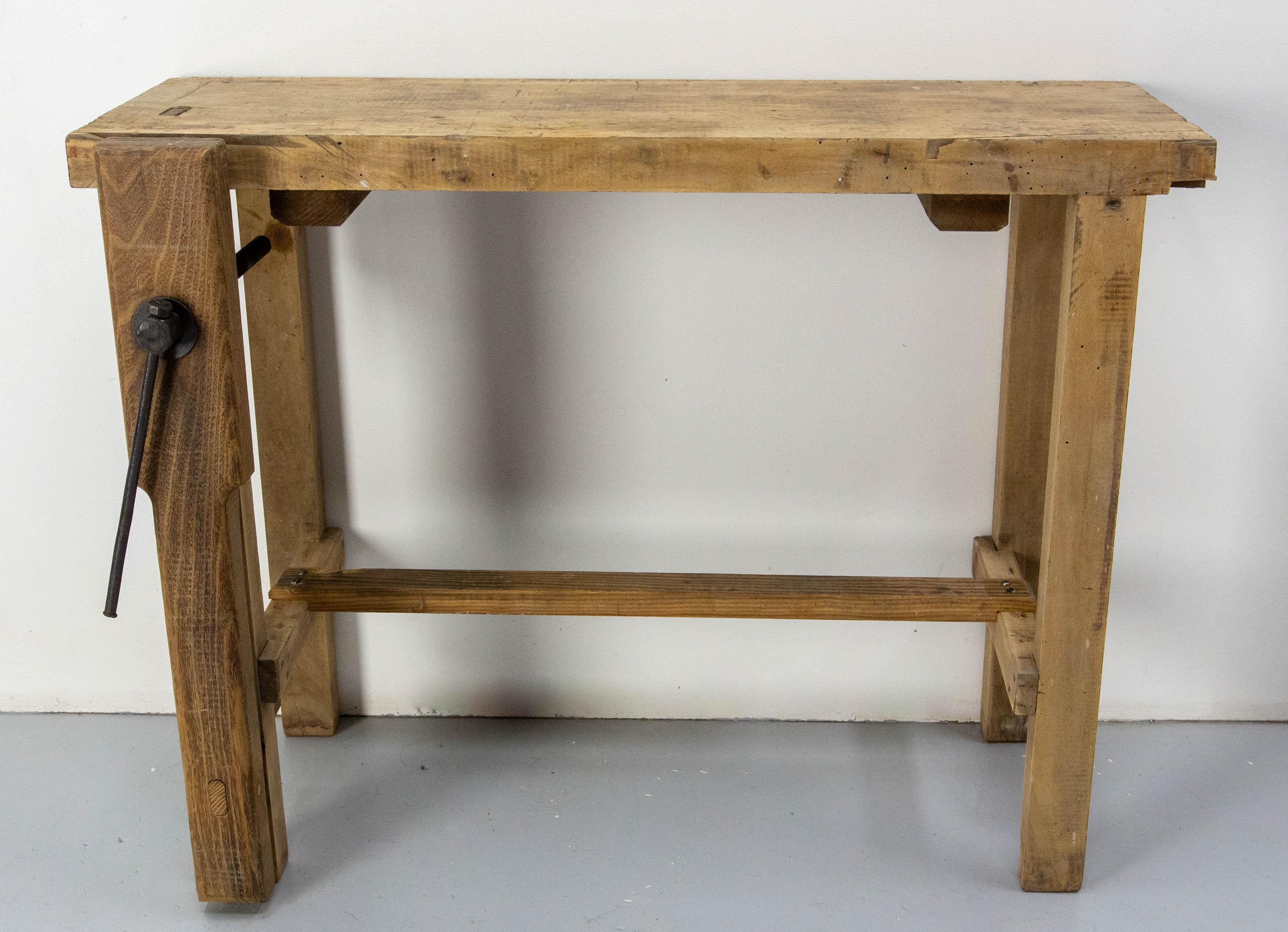 French work bench made circa 1950.
This carpenter work table is perfect to be used in an entry and in a part of a room as a console with character.
The nicks, scratches, dents, cuts, tell the story of the many objects made on this workbench.

Good