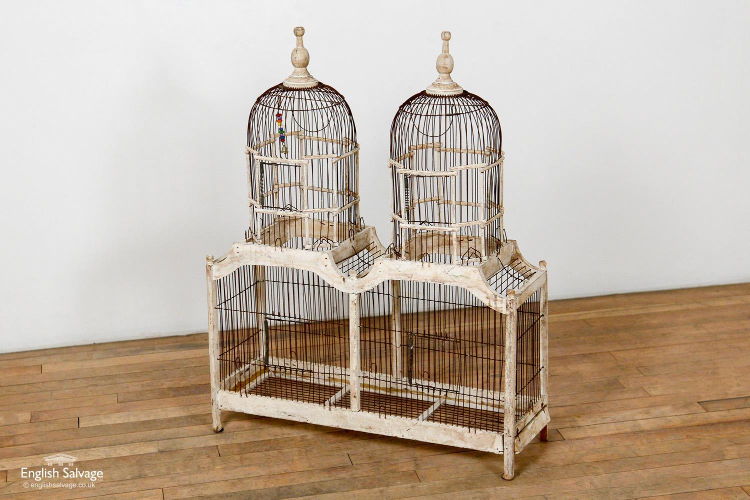 Exquisite vintage French double birdcage in wood and iron wirework. Weathered age- and use-related patina to the wood. It is a striking item, standing at almost a metre in height. A rare and beautiful find.