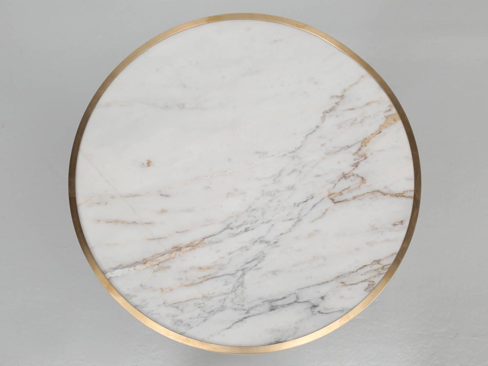 Vintage French bistro table with a beautiful Carrara marble and wrapped in brass.