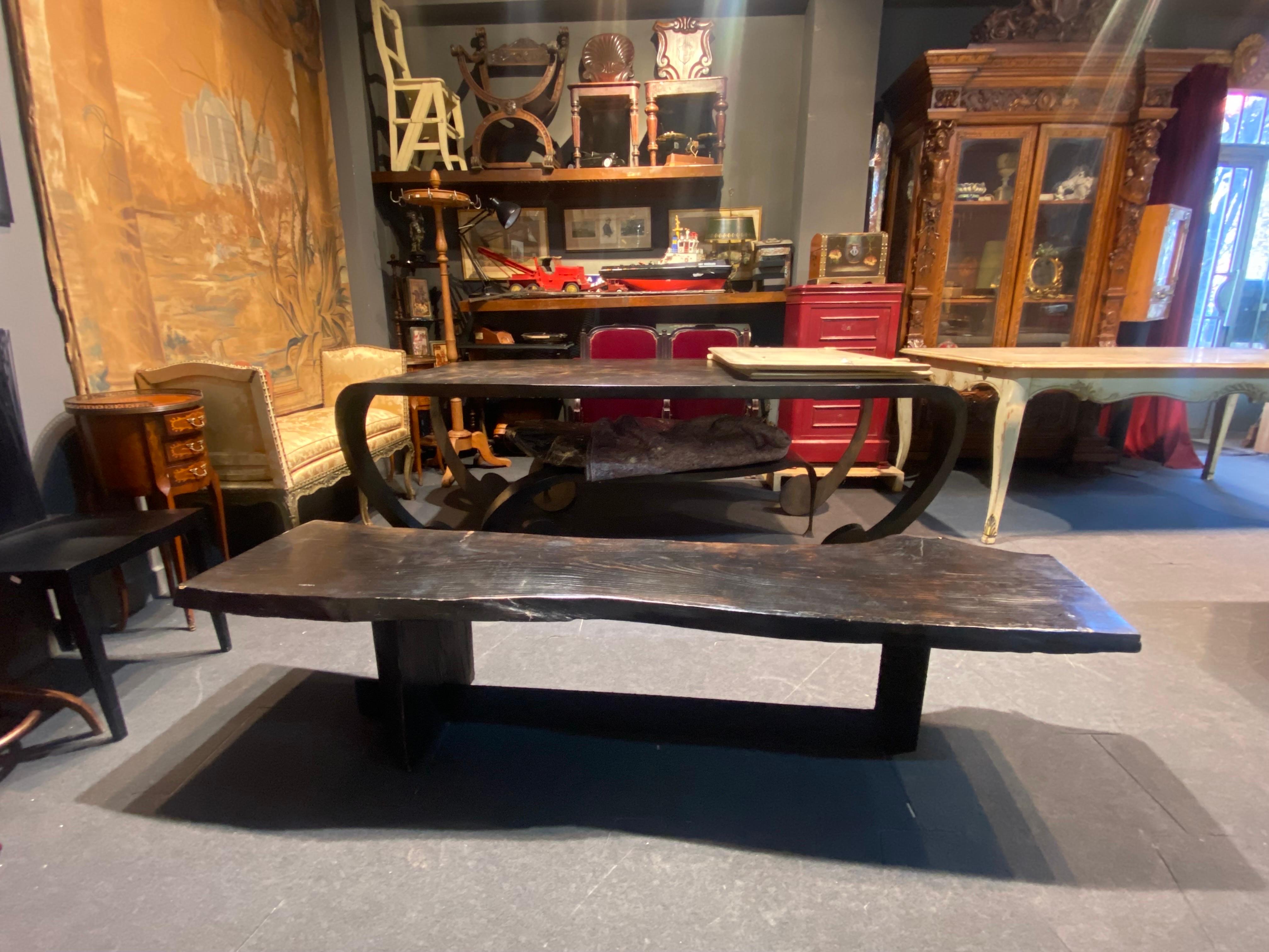 Exceptional piece representing Brutalist period - a black bench made of single piece of wood raised on a hand made metal structure with raw finish.
France, circa 1950