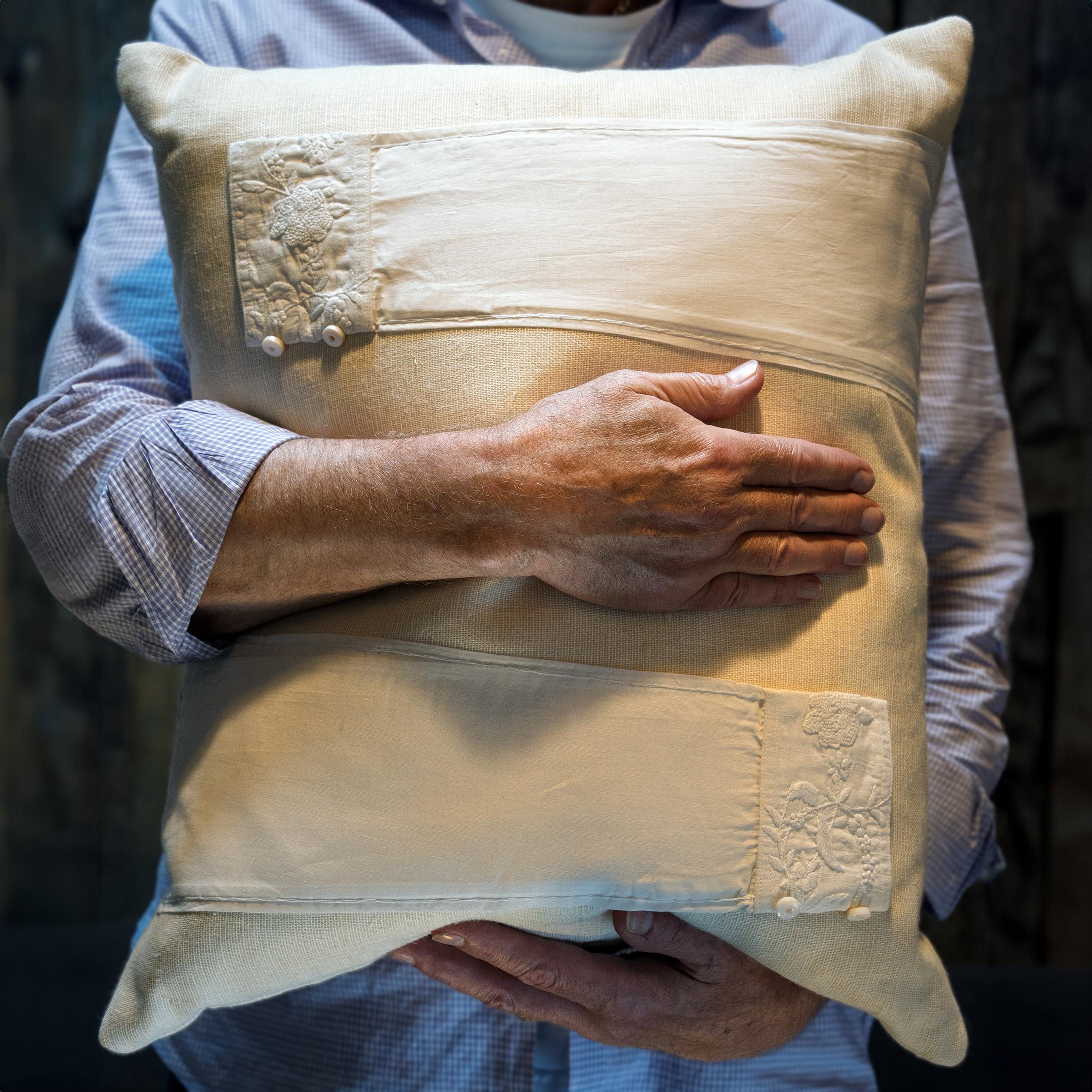 This hand-crafted pillow was designed by a local Chicago artist and textile historian who lovingly repurposes vintage fabrics, garments and embroidery fragments collected during her travels. Sewn from crème white Belgian linen, this down-filled