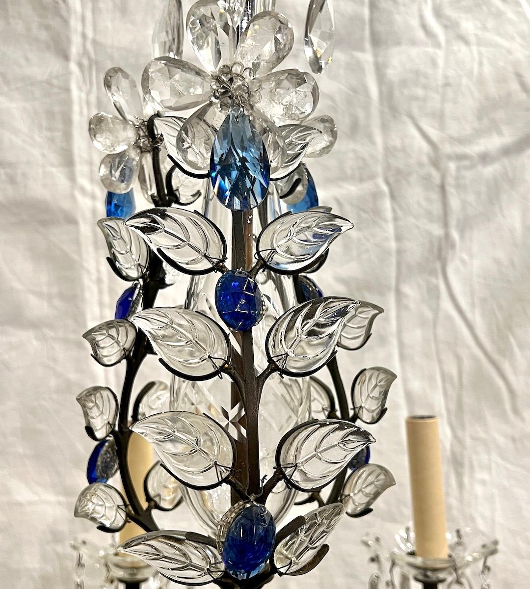 A circa 1950's patinated bronze chandelier with molded glass leaves and rock crystal flowers.

Measurements:
Current drop: 27