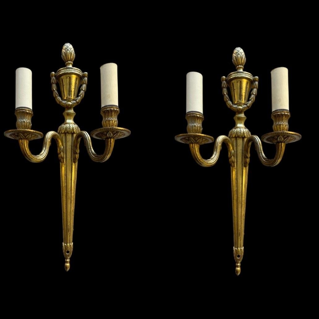 Enhance your living space with the timeless elegance of these exquisite mid 19th-century brass two-arm wall lights.

Skill-fully crafted, these lights are beautifully crowned with a delicately carved acorn motif, exuding a touch of nature's