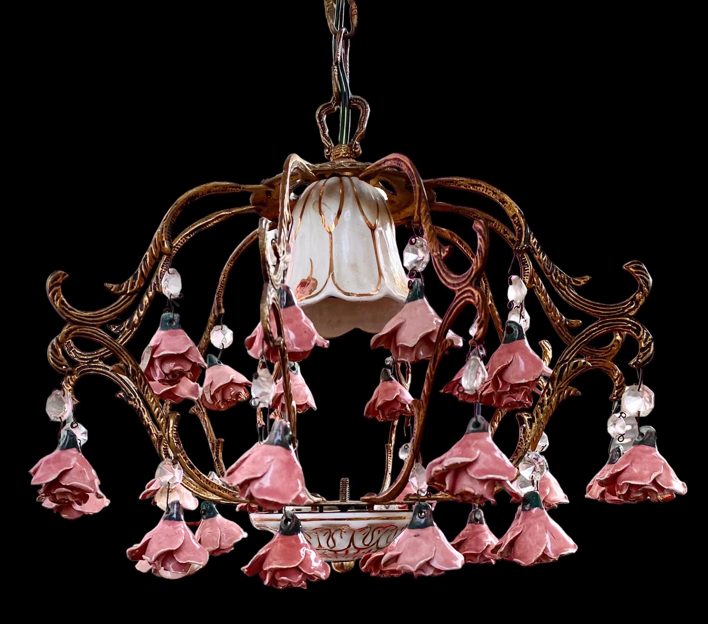 A vintage, charming French hanging chandelier, in brass with ceramic handmade flower décor.
Unusually complete and in good condition. 
Makers mark / hallmarks: none
Sourced: in Normandy, France 
Origin: French 
Age: circa 1960s-1970s

Would