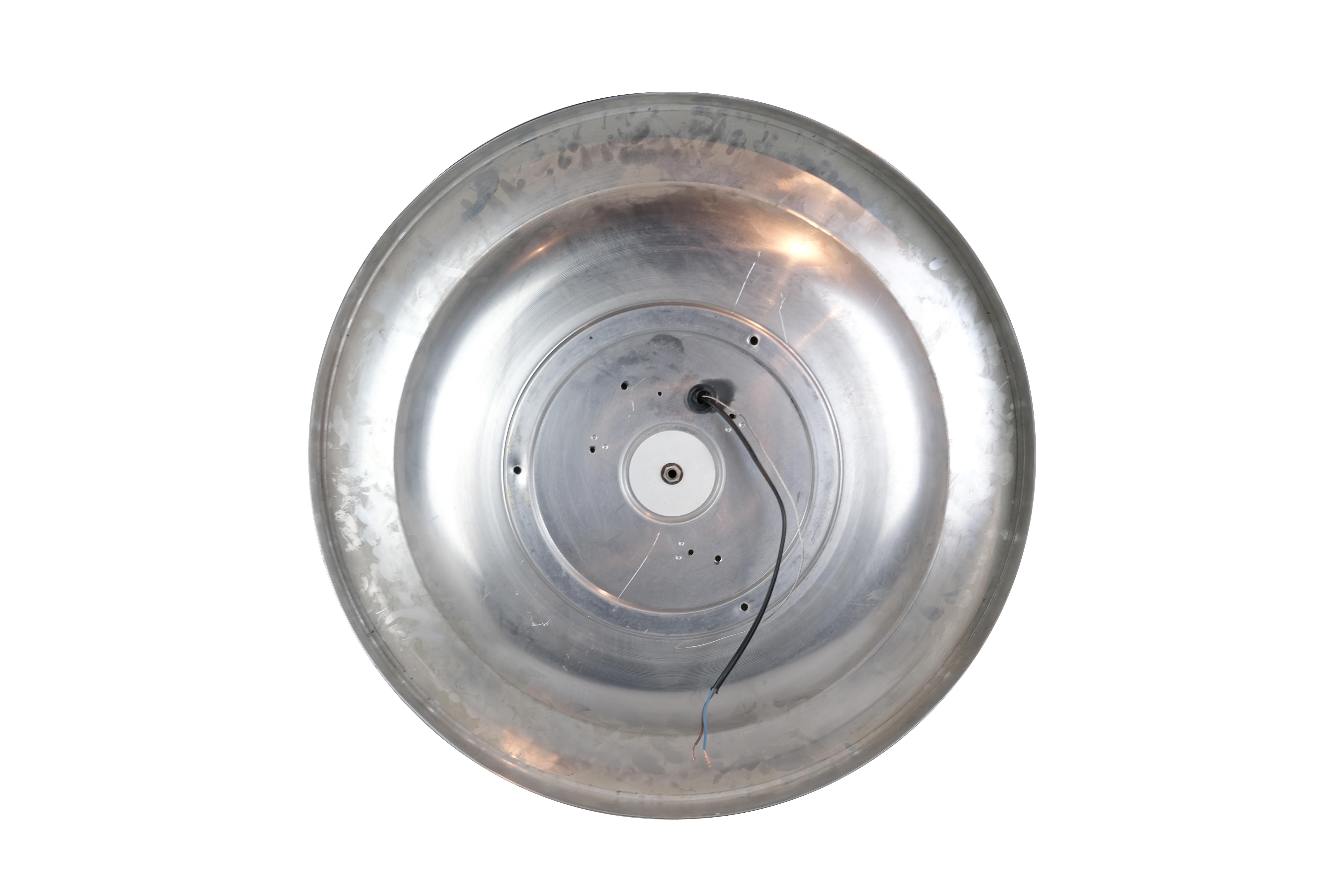 A large French round disk ceiling light with molded geometric designed glass and a brass rim. Four sockets. Sticker residue on brass rim will be removed.