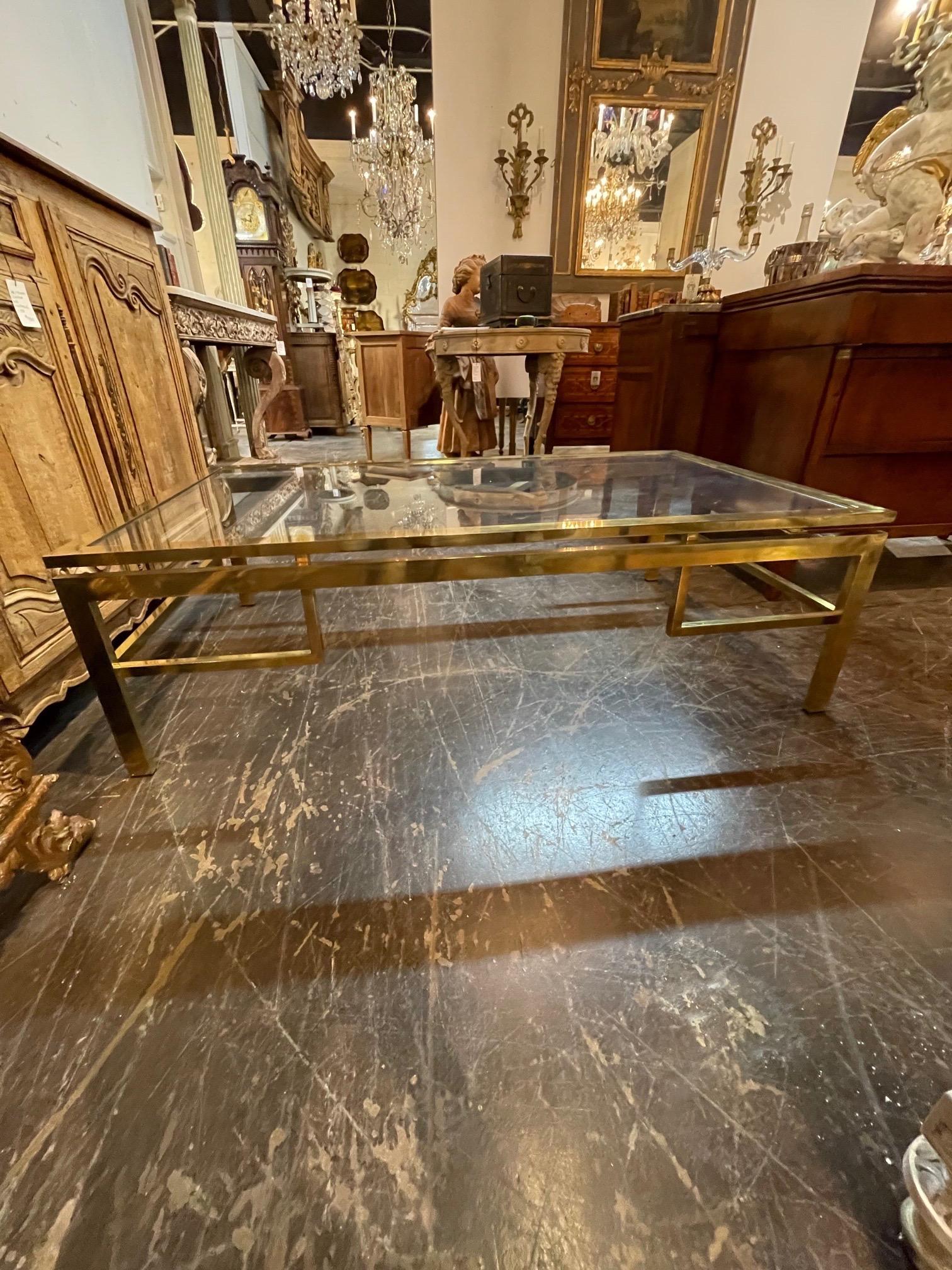 Lovely French vintage brass and glass coffee table. Creates a beautiful polished look. Very fine quality!