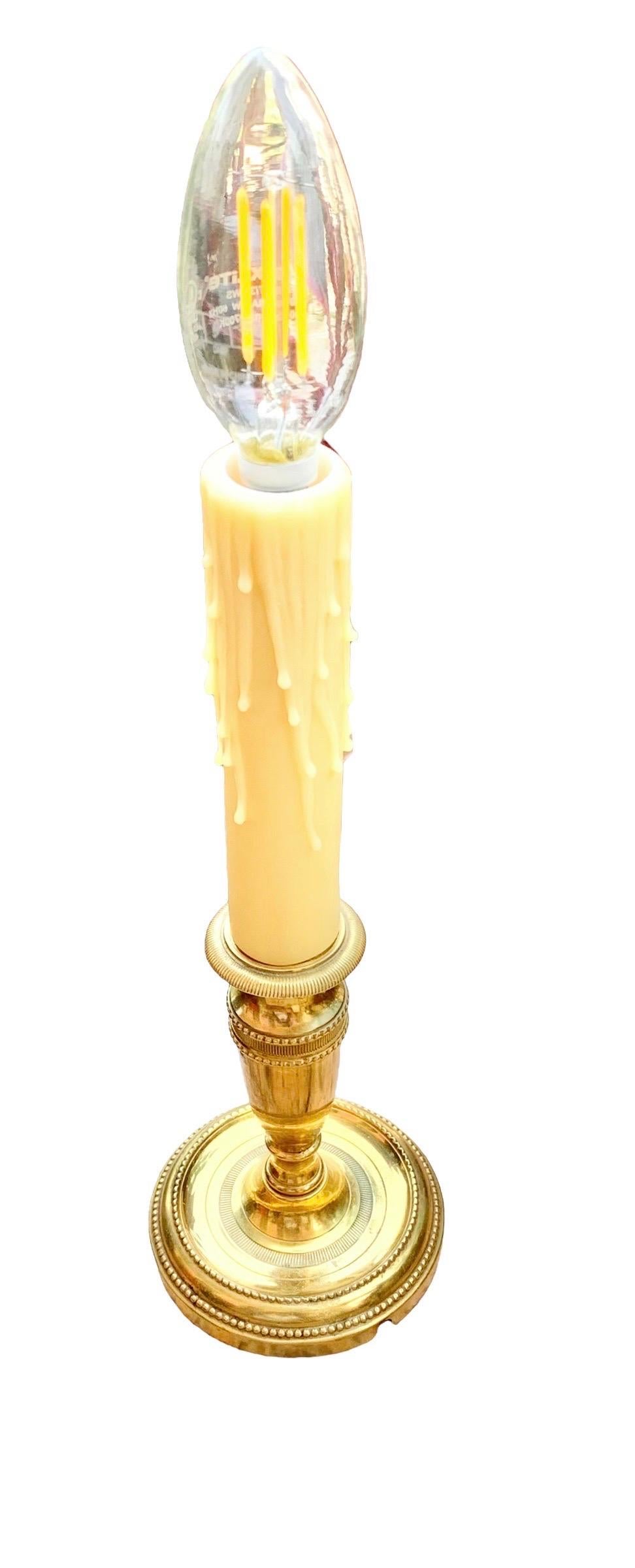 A lovely vintage French solid brass beaded candlestick lamp with a cream silk shade, an in line switch and new American socket.

Use it for a vanity lamp  in your dressing area, in a bookcase as an accent light or anywhere in a well appointed home. 