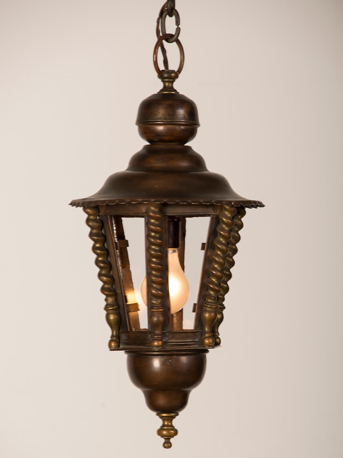 A handsome vintage French brass and copper hall lantern from France circa 1920 with a hexagon shape. The six panes of clear antique glass enable a maximum amount of light to be cast by this lantern and the socket will accommodate a standard base