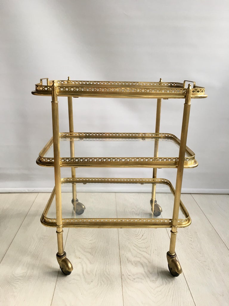 Perfectly formed vintage French drinks trolley with a rectangular lift off tray (measuring 45.5 cm wide and 30.5 cm deep).

Lacquered brass frame with a lovely aged patina

Perfect for smaller spaces

Measures: Stands 55 cm to top glass, 57 cm