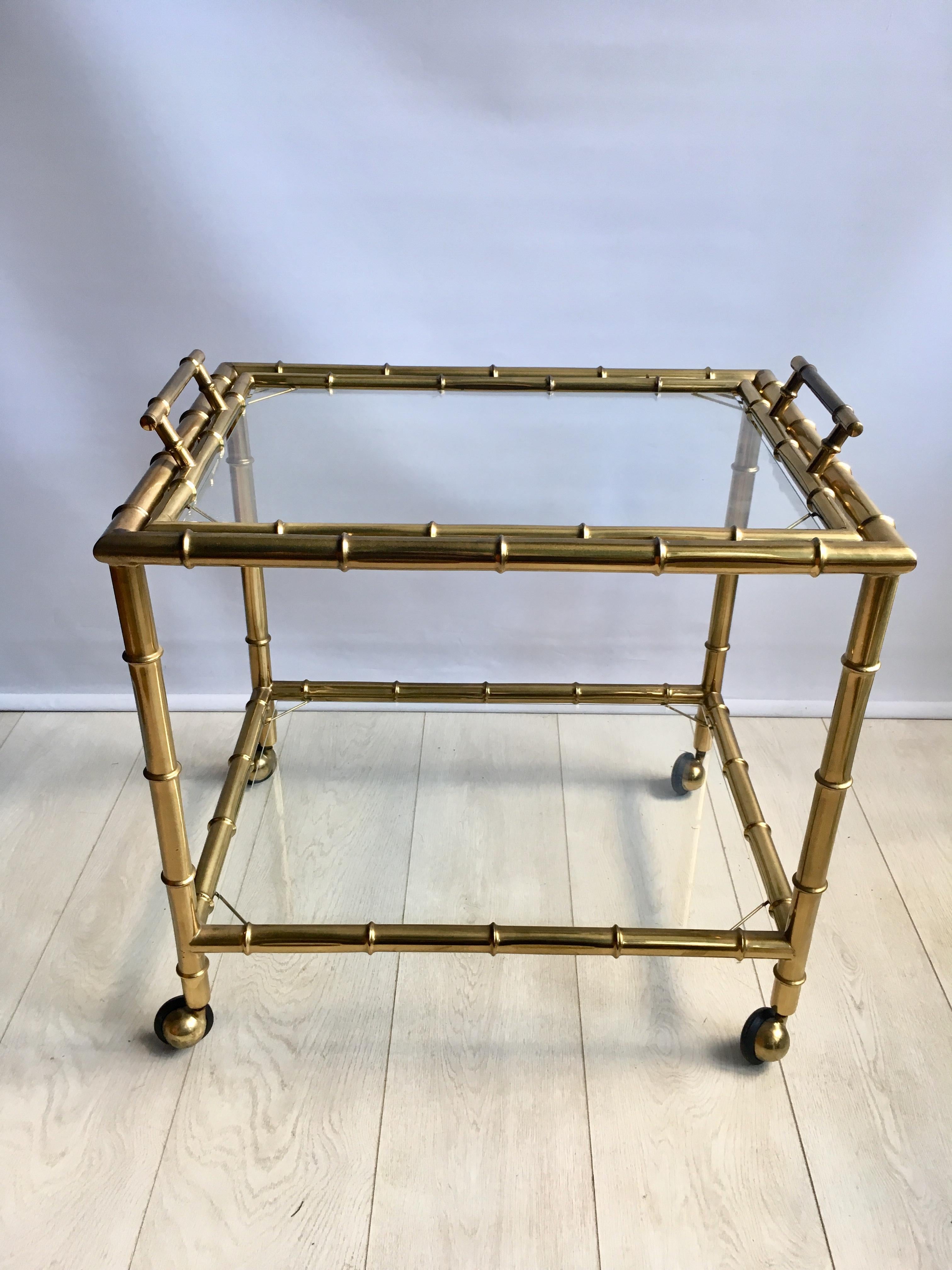 Chunky faux bamboo frame with lift off tray

Aged brass with lovely warm patina

Measures: 60cm wide, 45cm deep and stands 61.5cm tall to handles (55cm to glass).