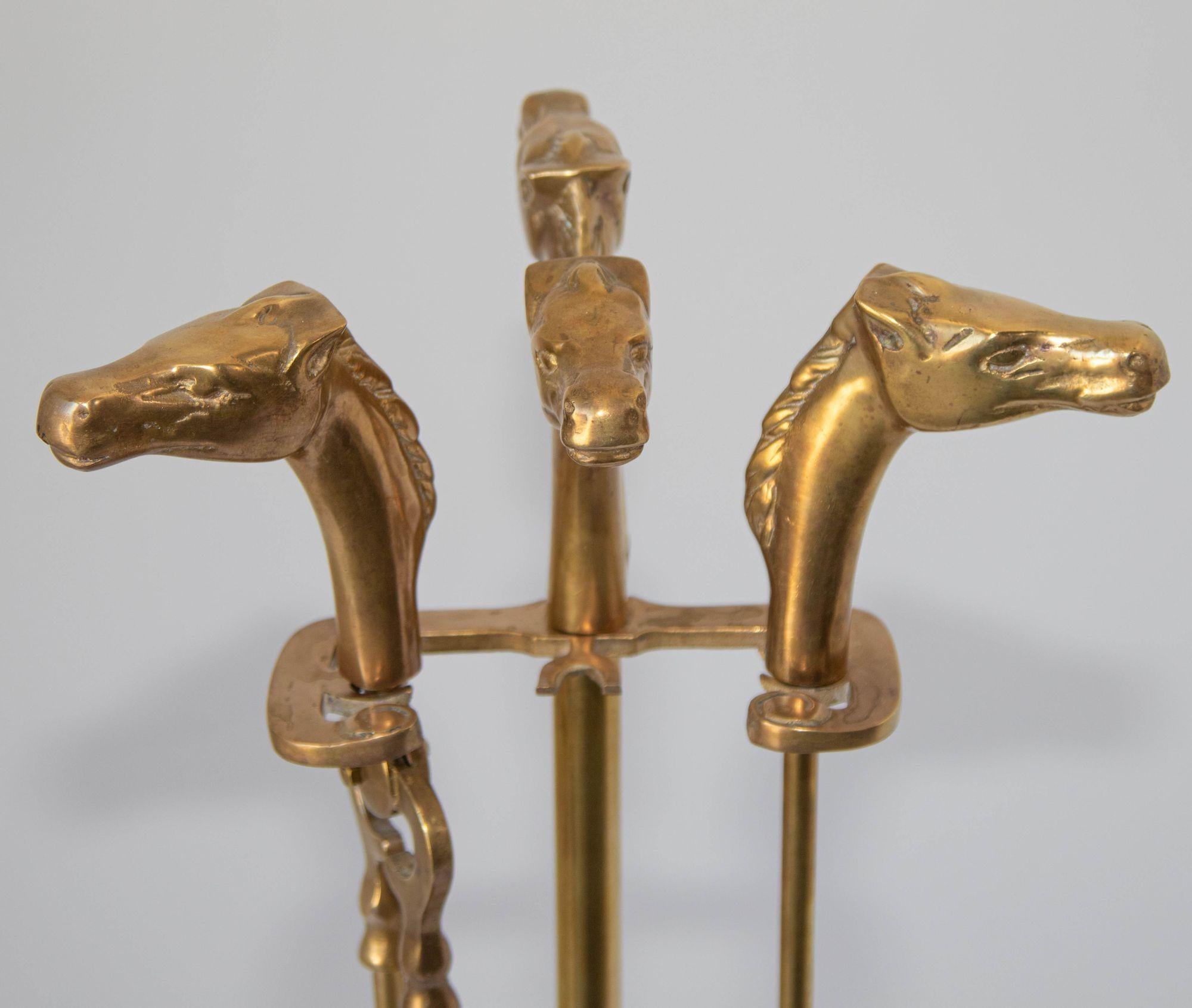 Vintage French Brass Fireplace Tools Vintage Set of 1950s with Horse Head Motif.
Elegant and beautiful set of four pieces solid brass French fire tools on stand with equestrian horse bust finials resting on rectangular decorative cast brass base.